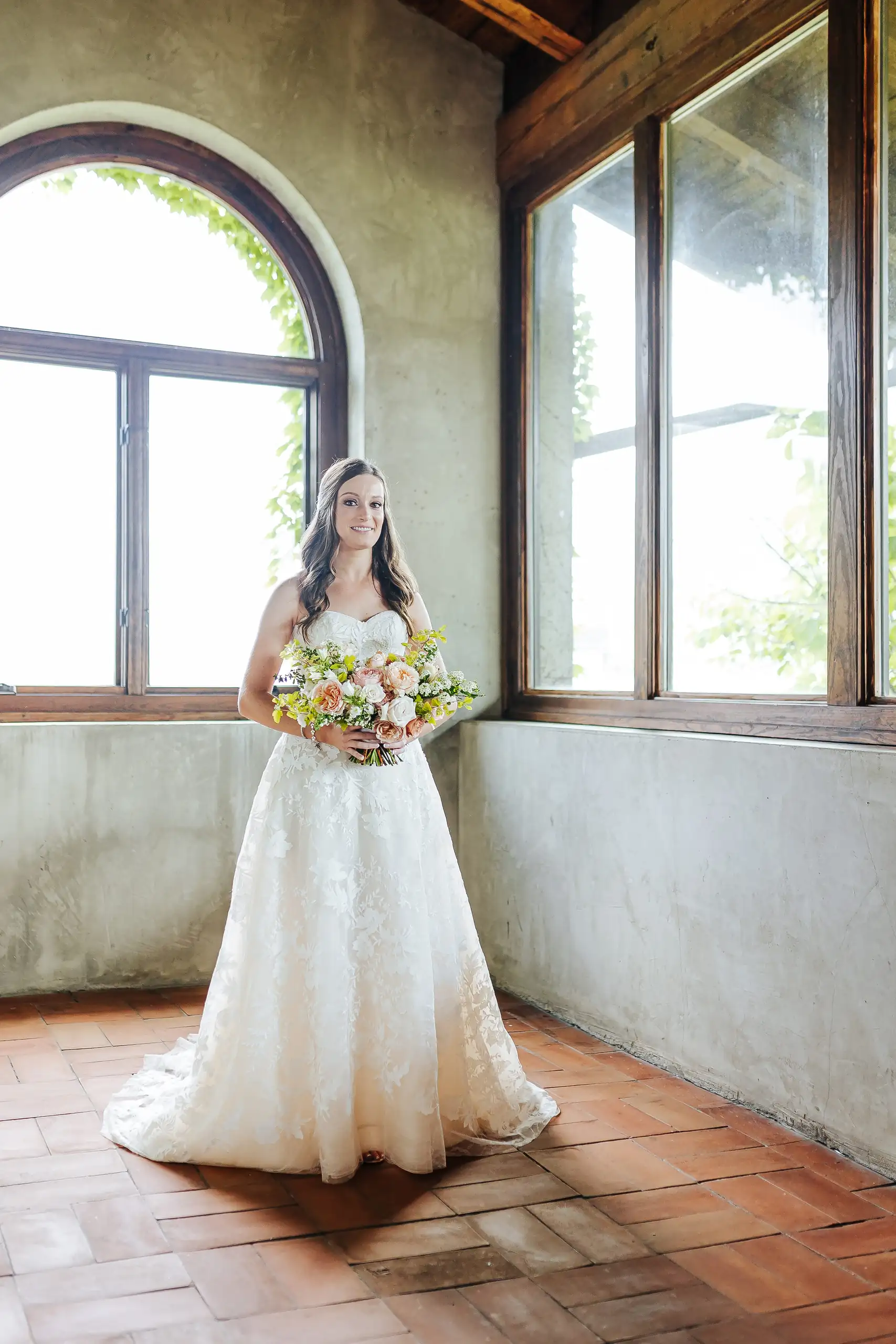 Bridal Portraits: the bride in the room with the arched windows, at their wedding at Summerour Studio in Atlanta, GA