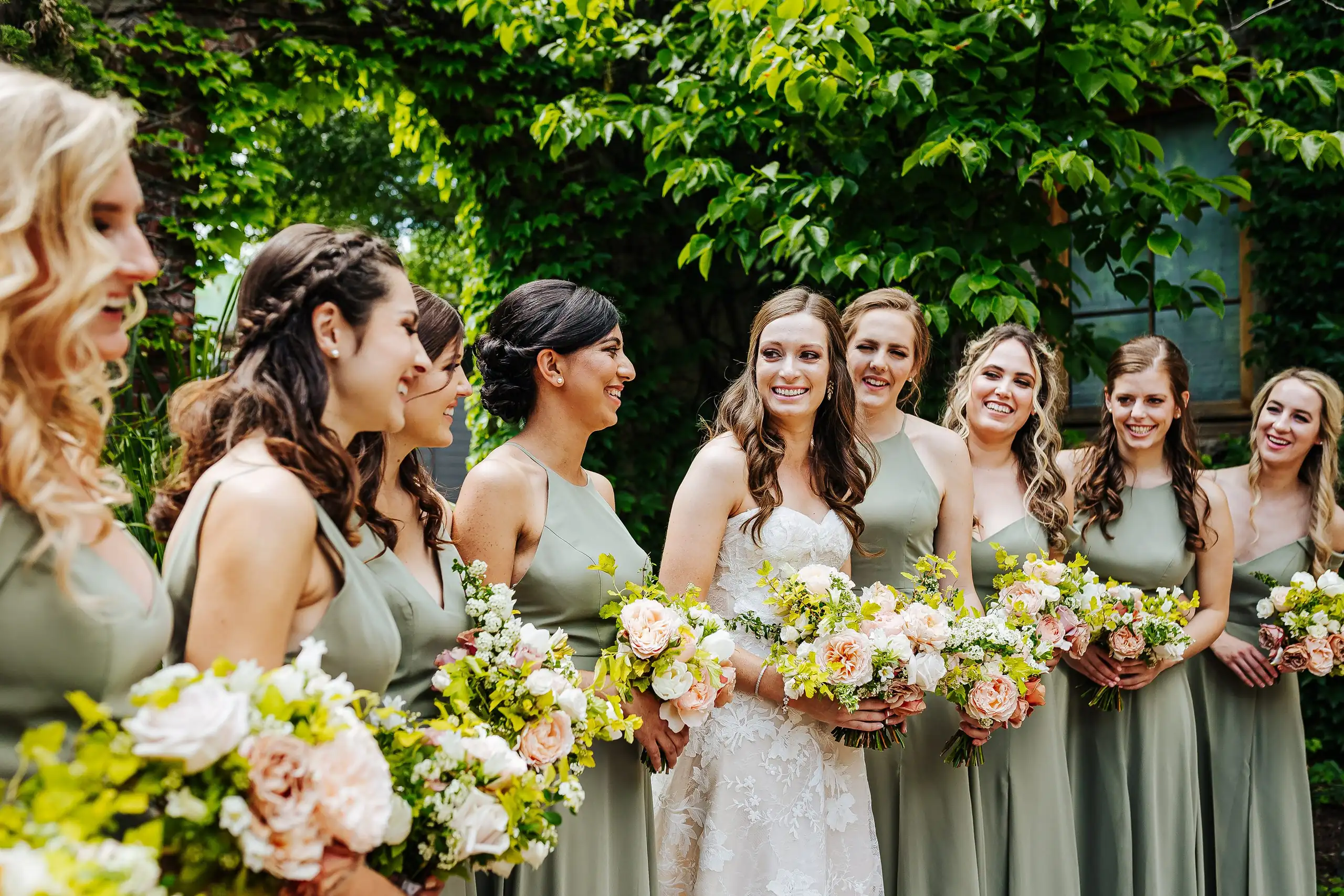 Wedding Party: the bridesmaids in sage with their bouquets, at their wedding at Summerour Studio in Atlanta, GA