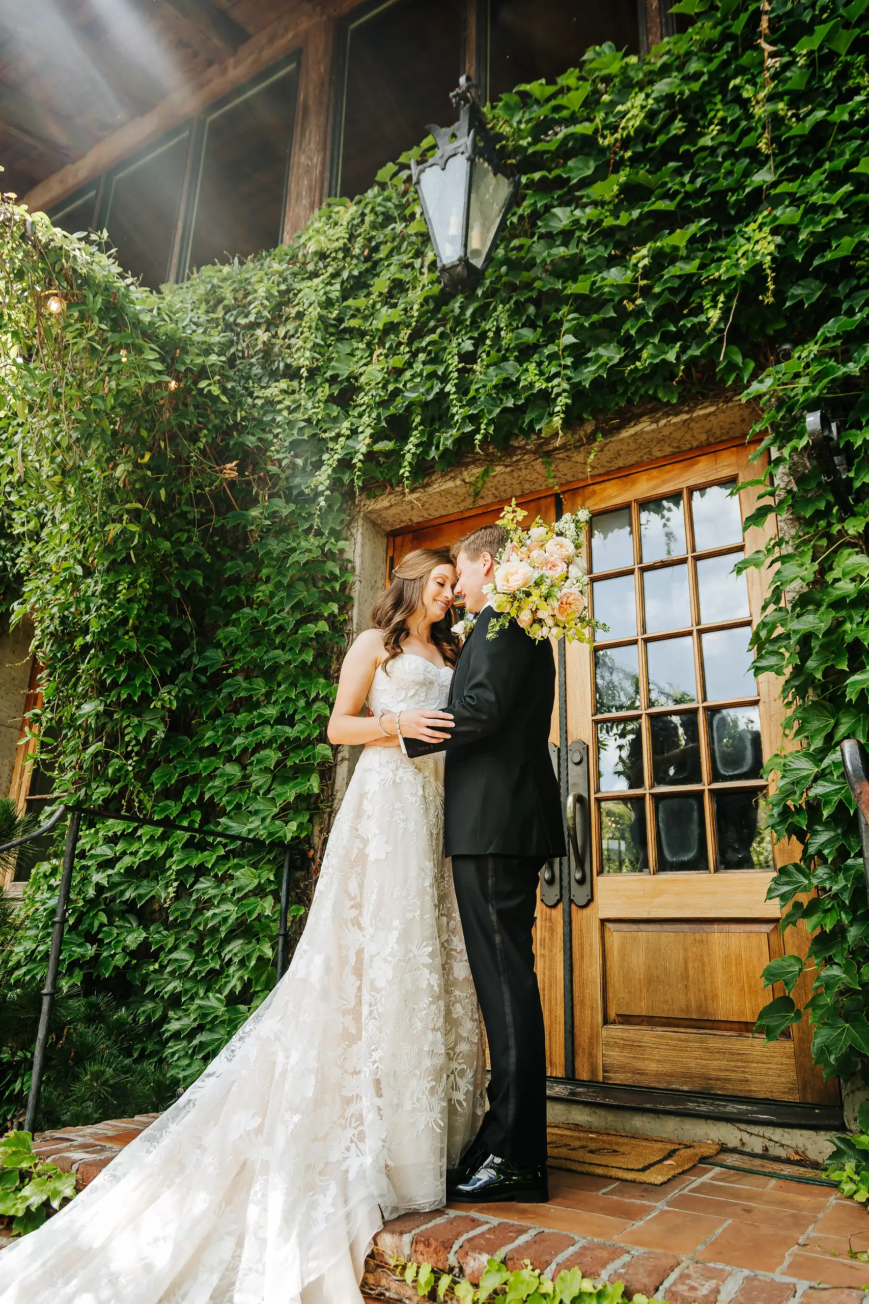 Wedding Formals: the couple by the ivy-framed door, at their wedding at Summerour Studio in Atlanta, GA