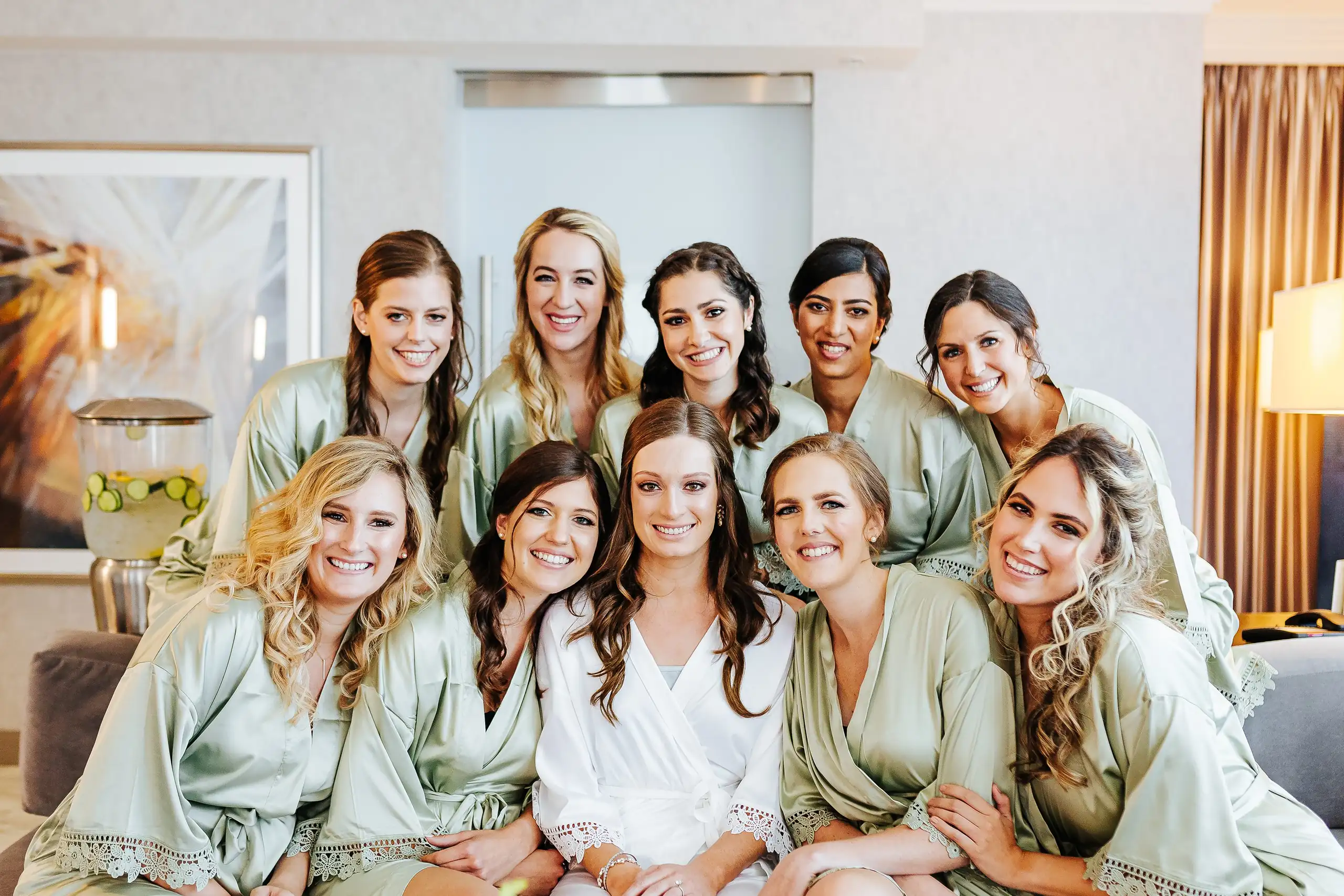 Getting Ready: the bride and her bridesmaids in sage robes, before their wedding at Summerour Studio in Atlanta, GA