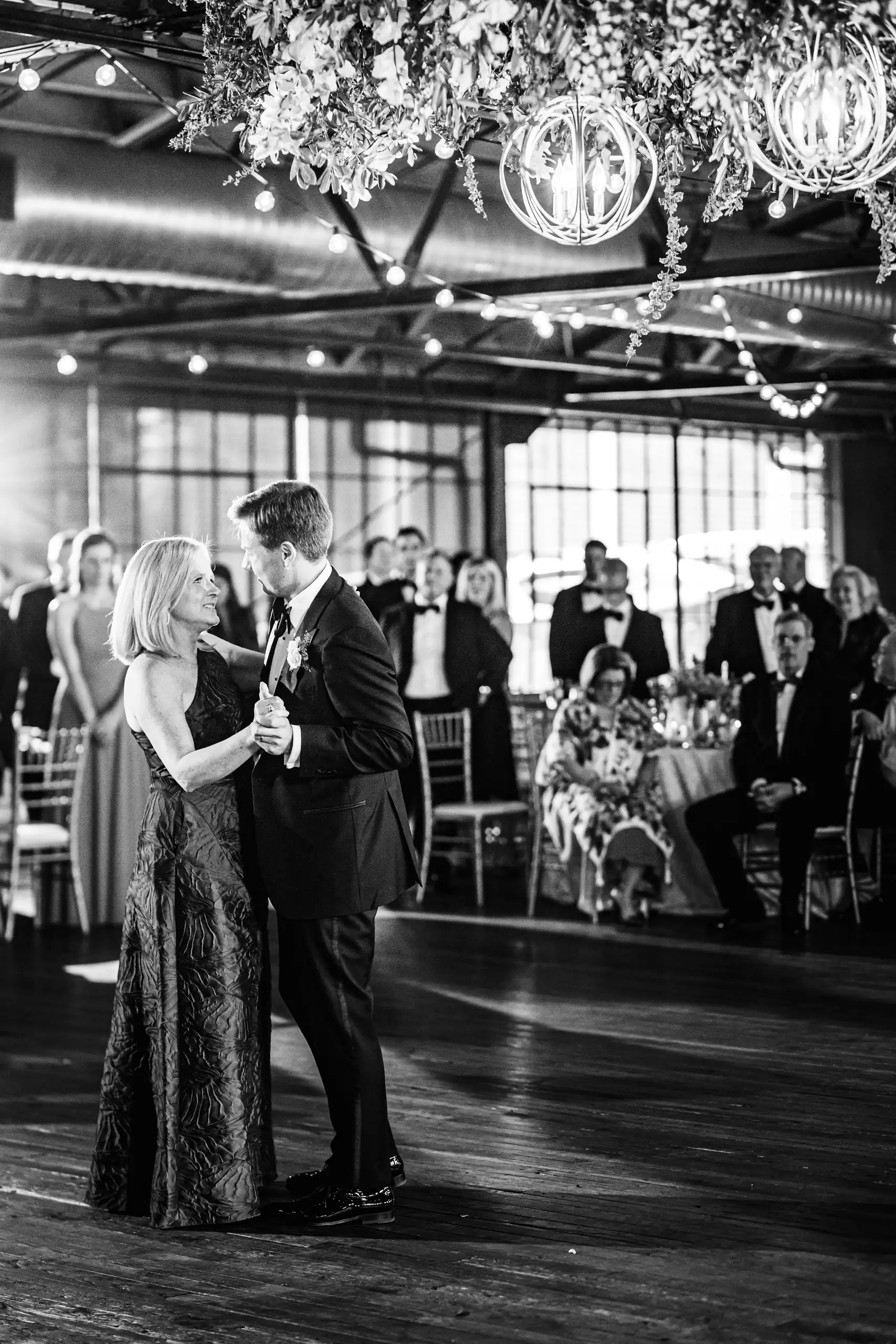 Parent Dance: a parent dance on the floor, in black and white, at their wedding at Summerour Studio in Atlanta, GA