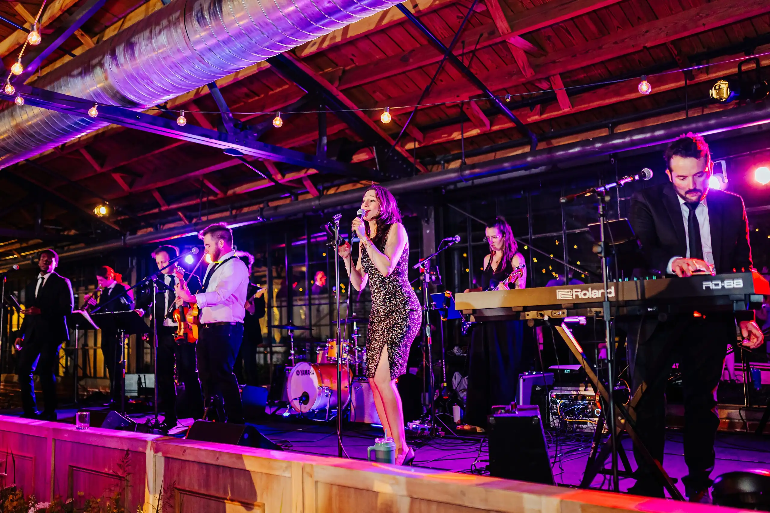 Wedding Reception: the live band on stage, at their wedding at Summerour Studio in Atlanta, GA