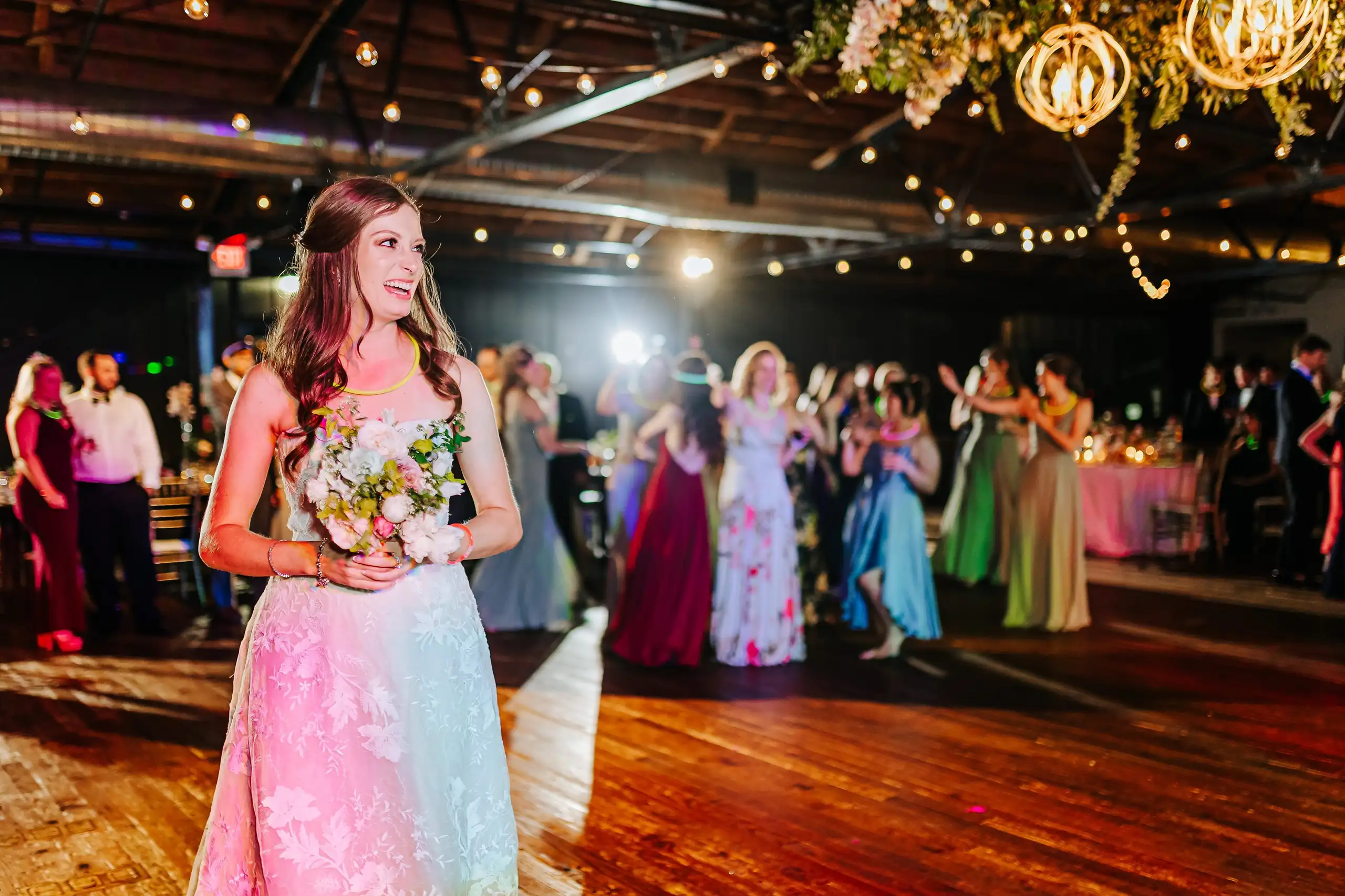 Bouquet Toss: the guest who caught the bouquet, at their wedding at Summerour Studio in Atlanta, GA