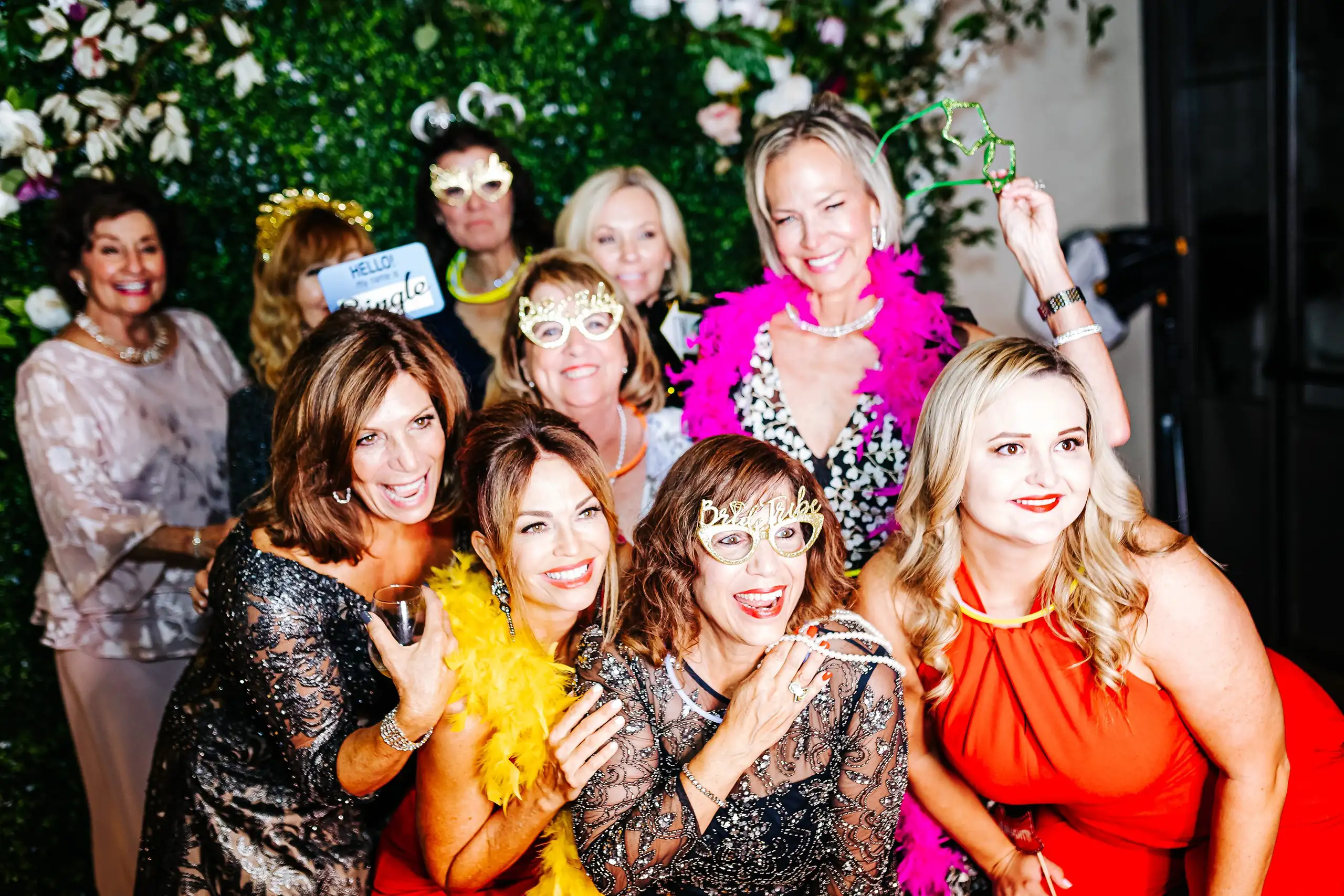 Wedding Reception: guests posing with feather boas and props, at their wedding at Summerour Studio in Atlanta, GA