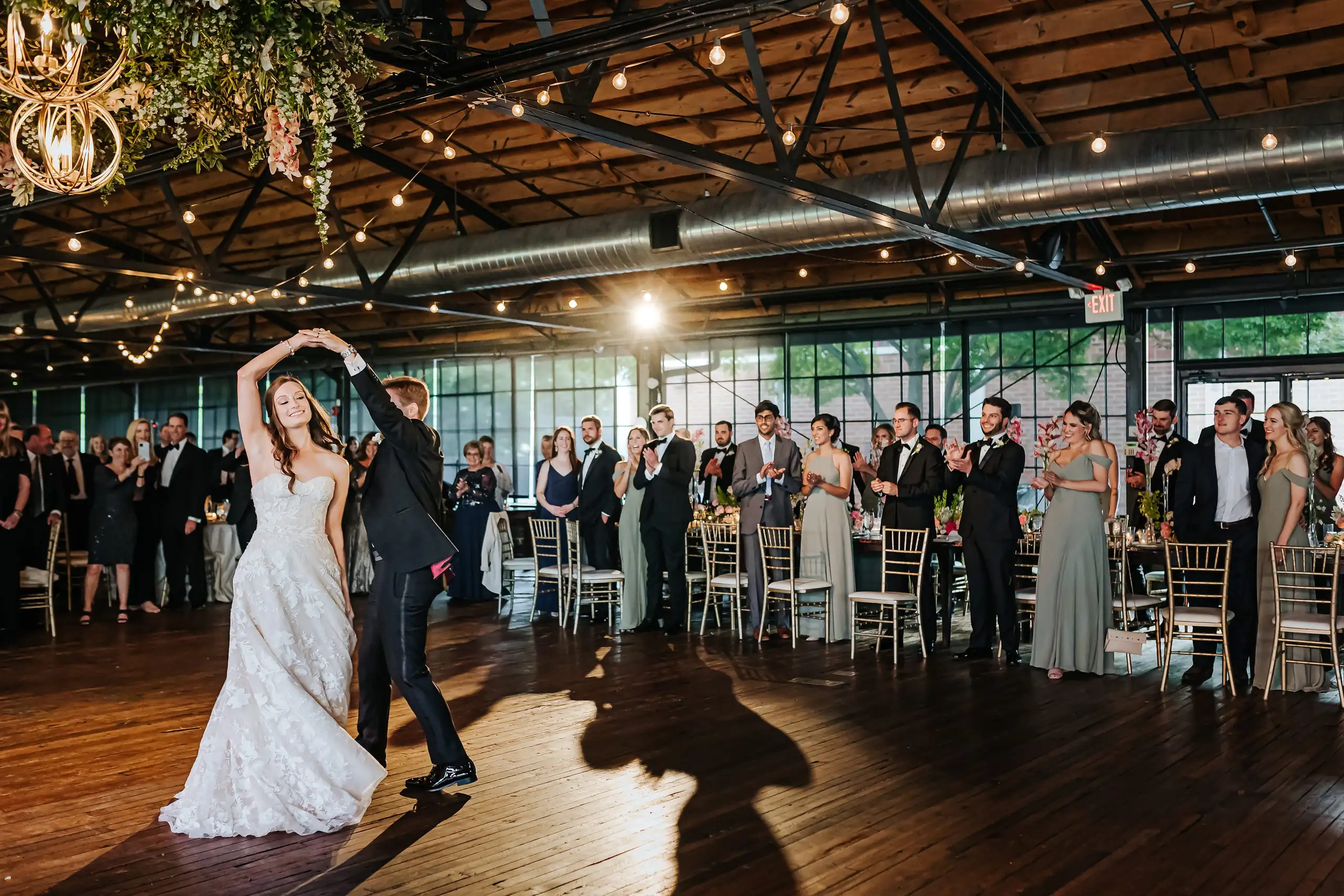 First Dance: the couple dancing as their guests watch, at their wedding at Summerour Studio in Atlanta, GA