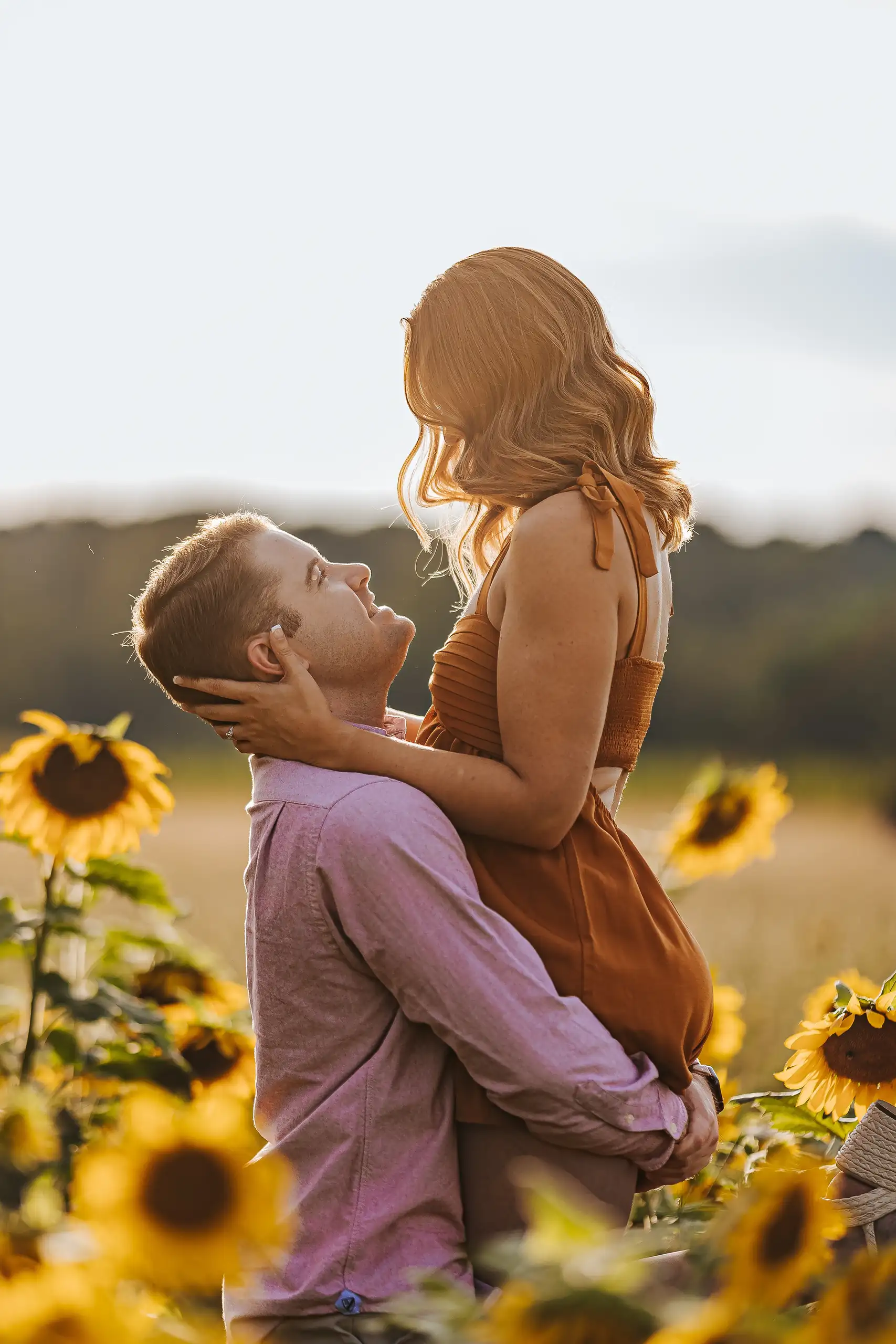 Engagement Portraits: him looking up at her as he lifts her, during their engagement session at Prospect Farms in Lawrenceville, GA