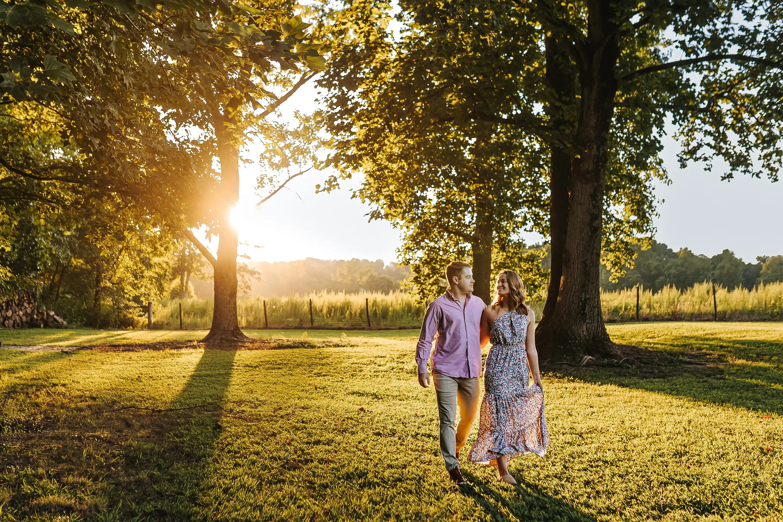 Engagement Portraits: the couple small under the big trees at sunset, during their engagement session at Prospect Farms in Lawrenceville, GA