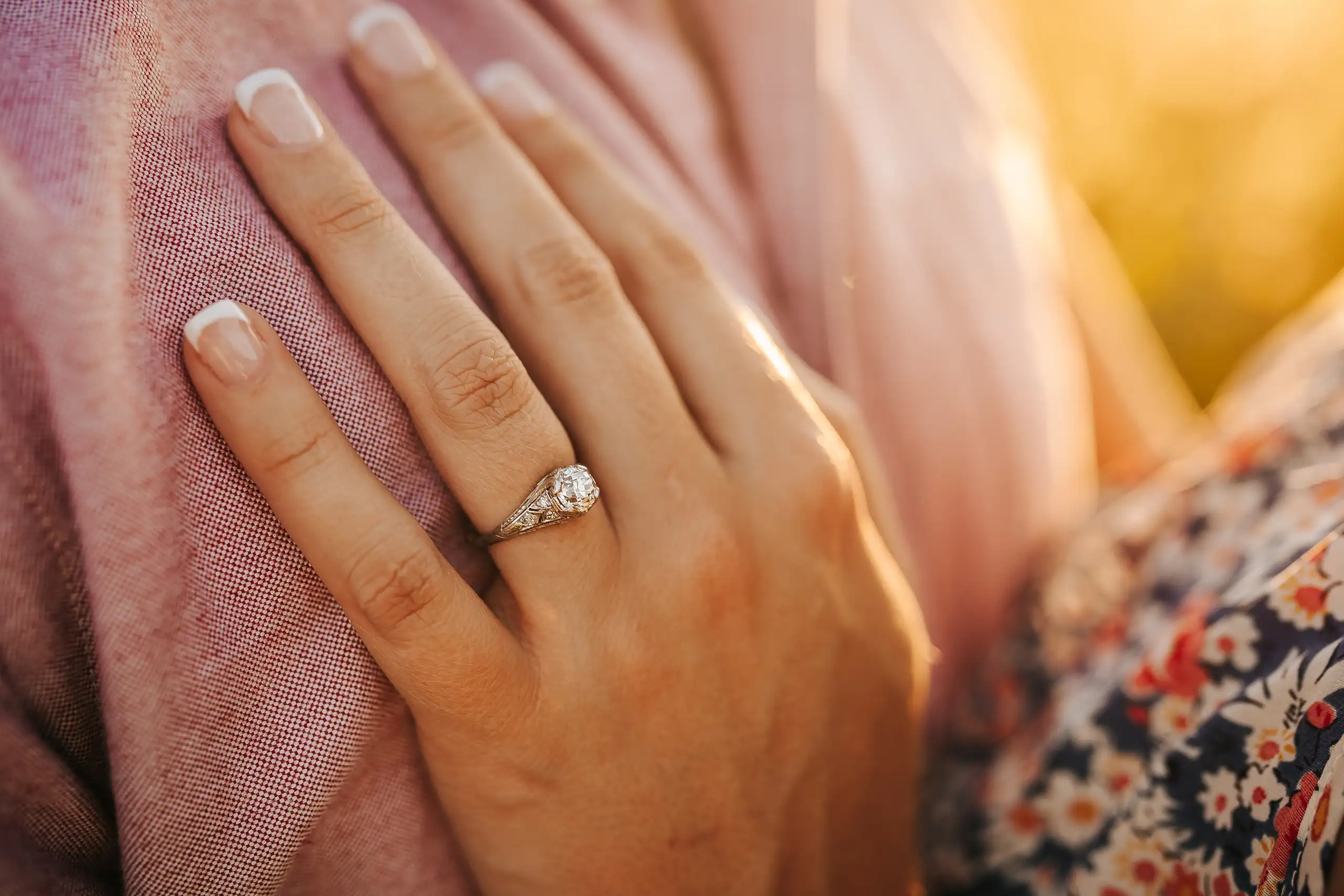 Engagement Portraits: her hand and engagement ring against his shirt, during their engagement session at Prospect Farms in Lawrenceville, GA