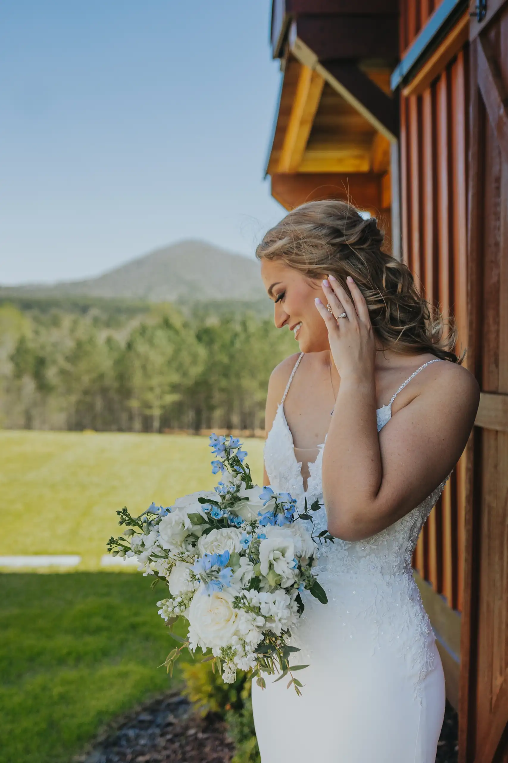 Bridal Portraits: the bride in profile, the mountains behind, at their wedding at The Venue at Sharp Mountain in Jasper, GA