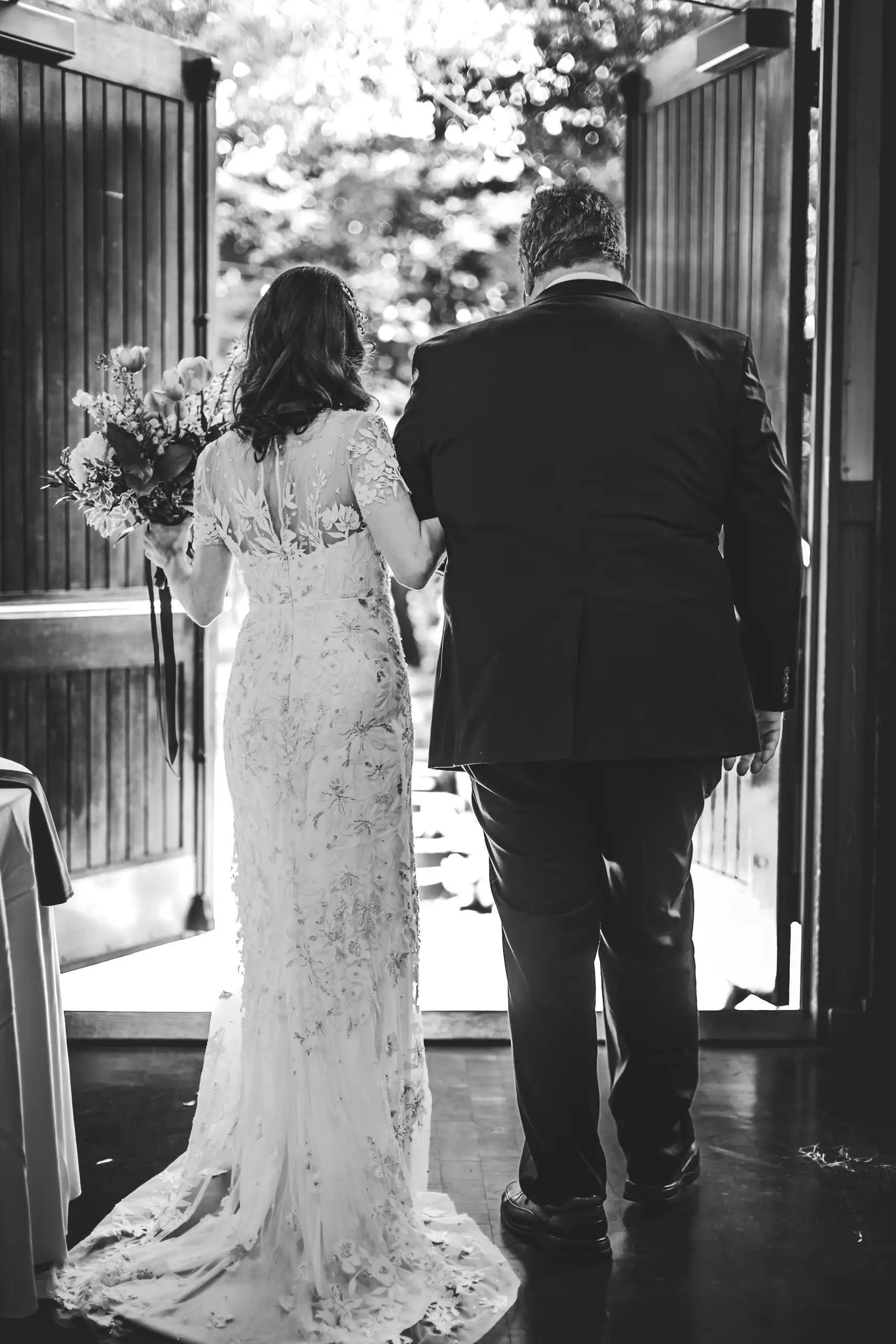 Processional: the bride and her father at the doorway, at their wedding at the Trolley Barn in Atlanta, GA