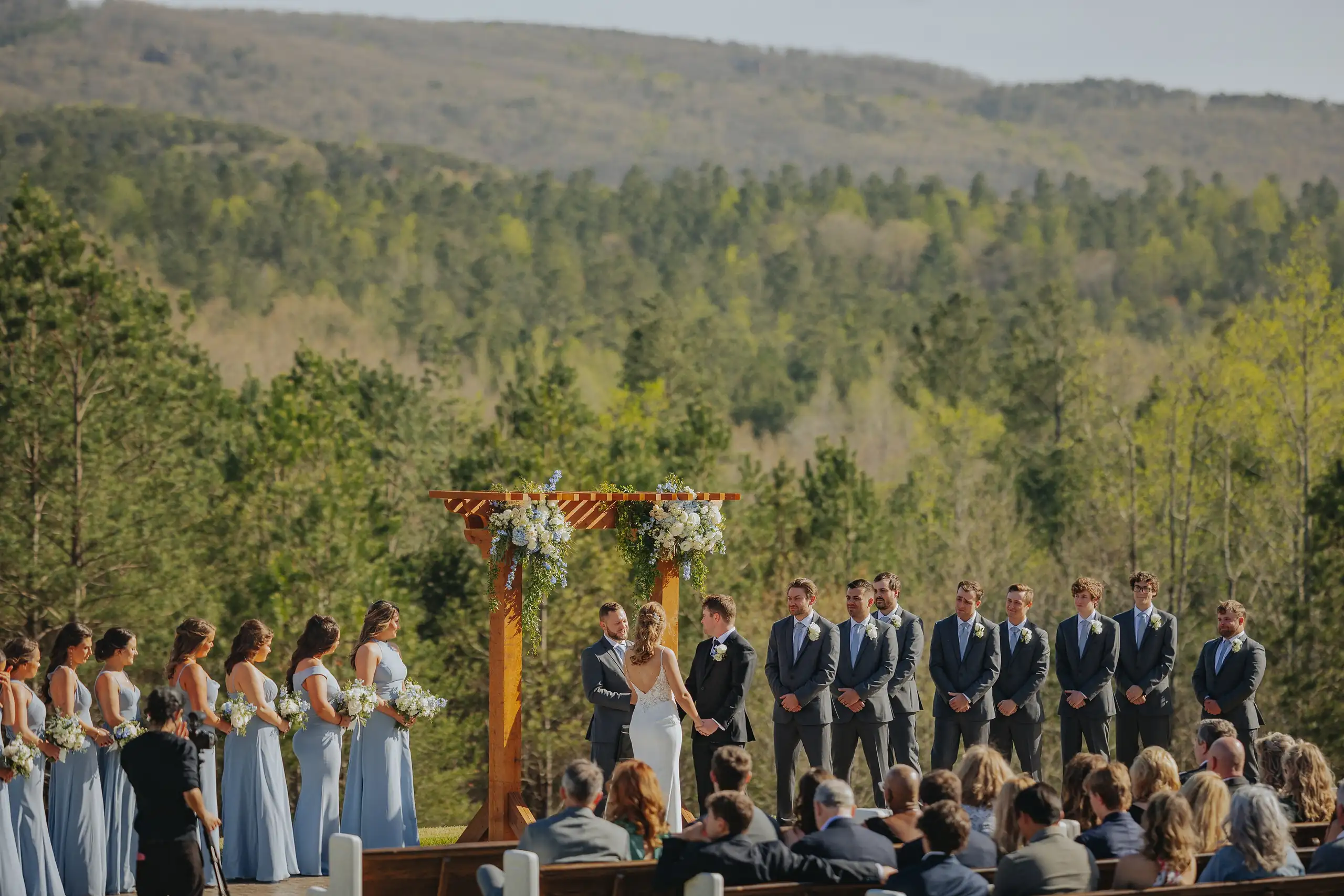 Wedding Ceremony: the ceremony from behind, the ridge beyond, at their wedding at The Venue at Sharp Mountain in Jasper, GA