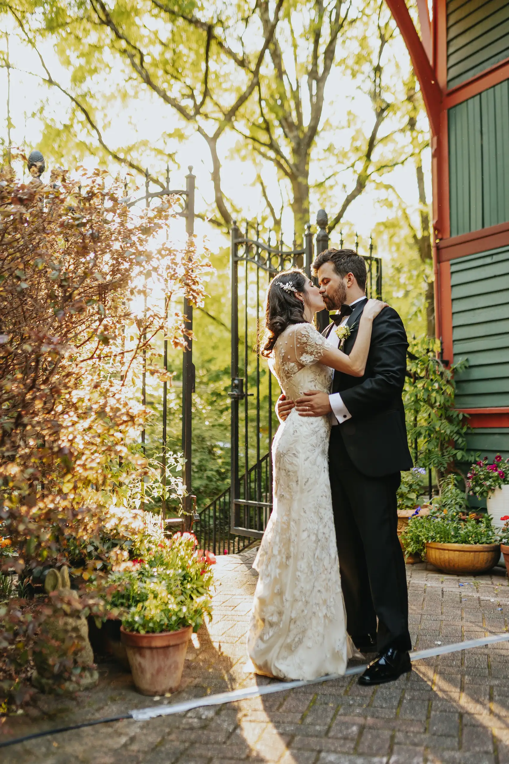 Wedding Formals: the couple in the gateway, backlit, at their wedding at the Trolley Barn in Atlanta, GA