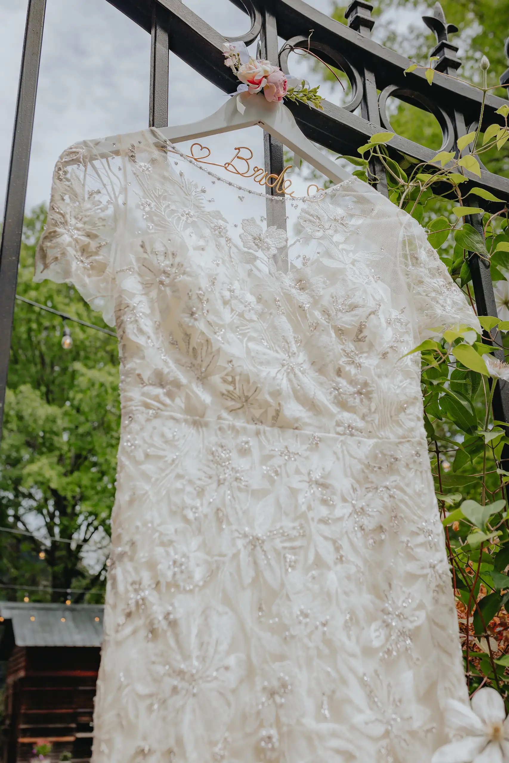 Wedding Details: the lace wedding gown hanging outdoors, at a wedding at the Trolley Barn in Atlanta, GA