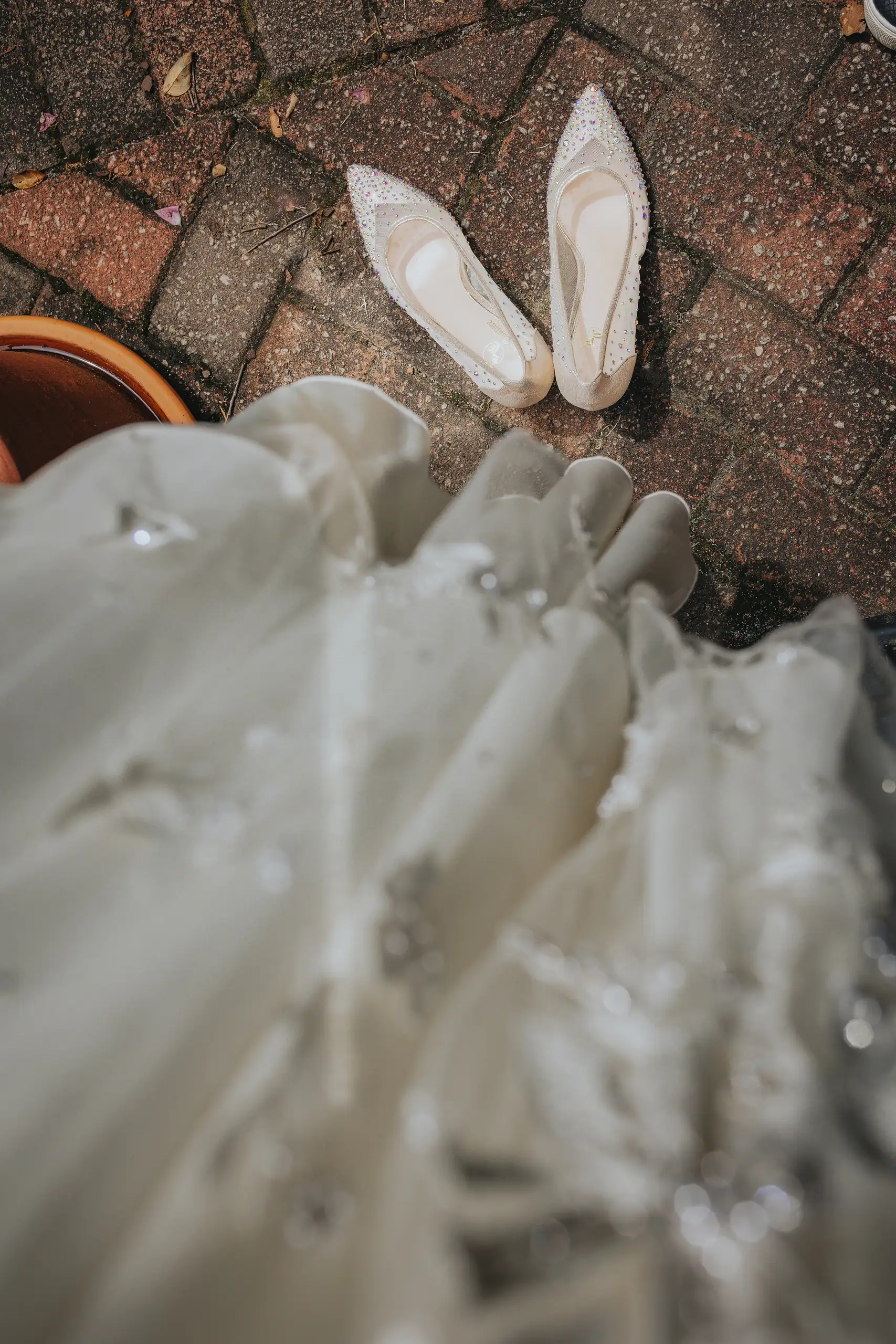 Wedding Details: the bride's ivory heels beside the lace hem, at a wedding at the Trolley Barn in Atlanta, GA