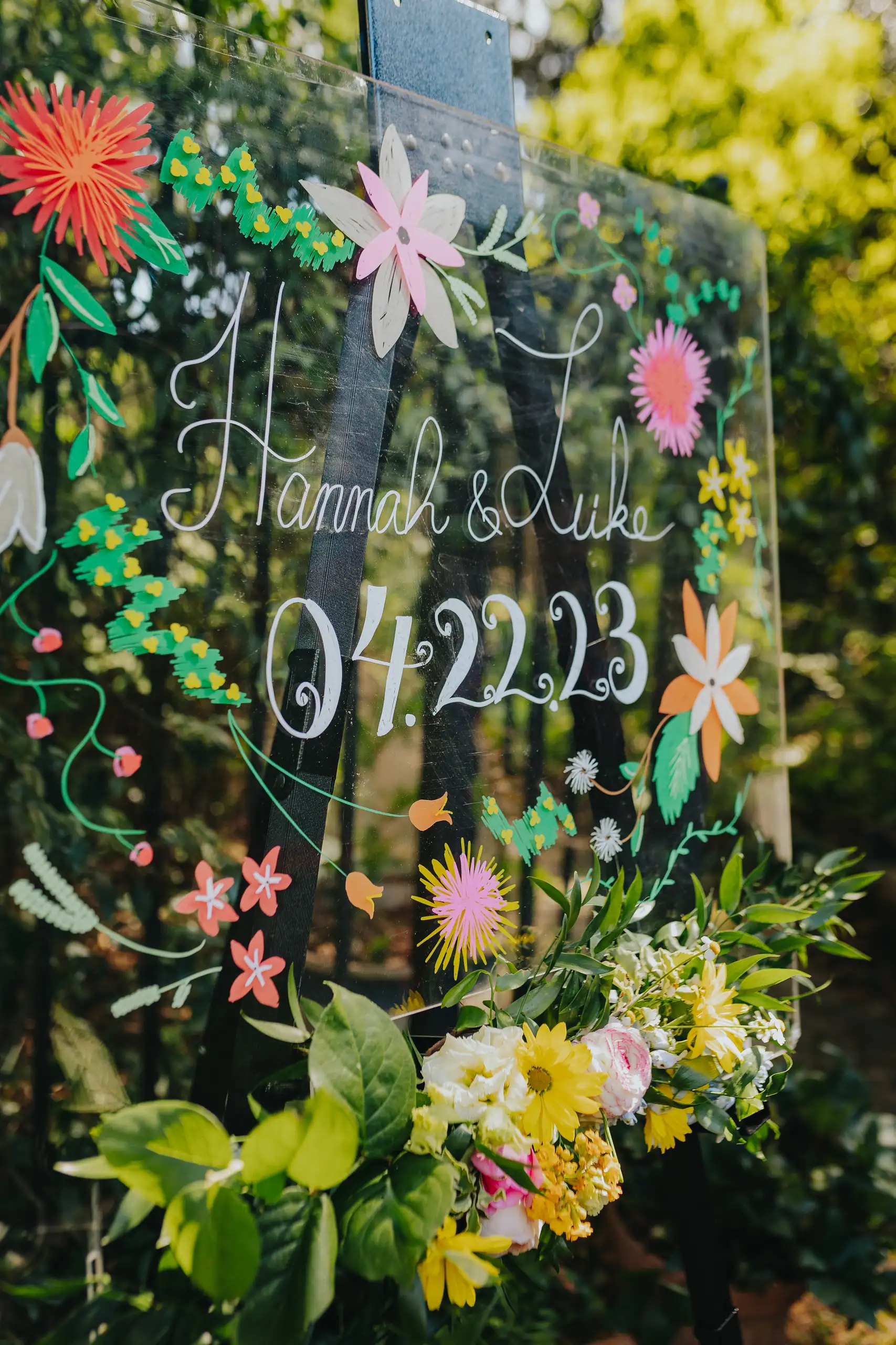 Wedding Details: a chalkboard welcome sign painted with flowers, at a wedding at the Trolley Barn in Atlanta, GA