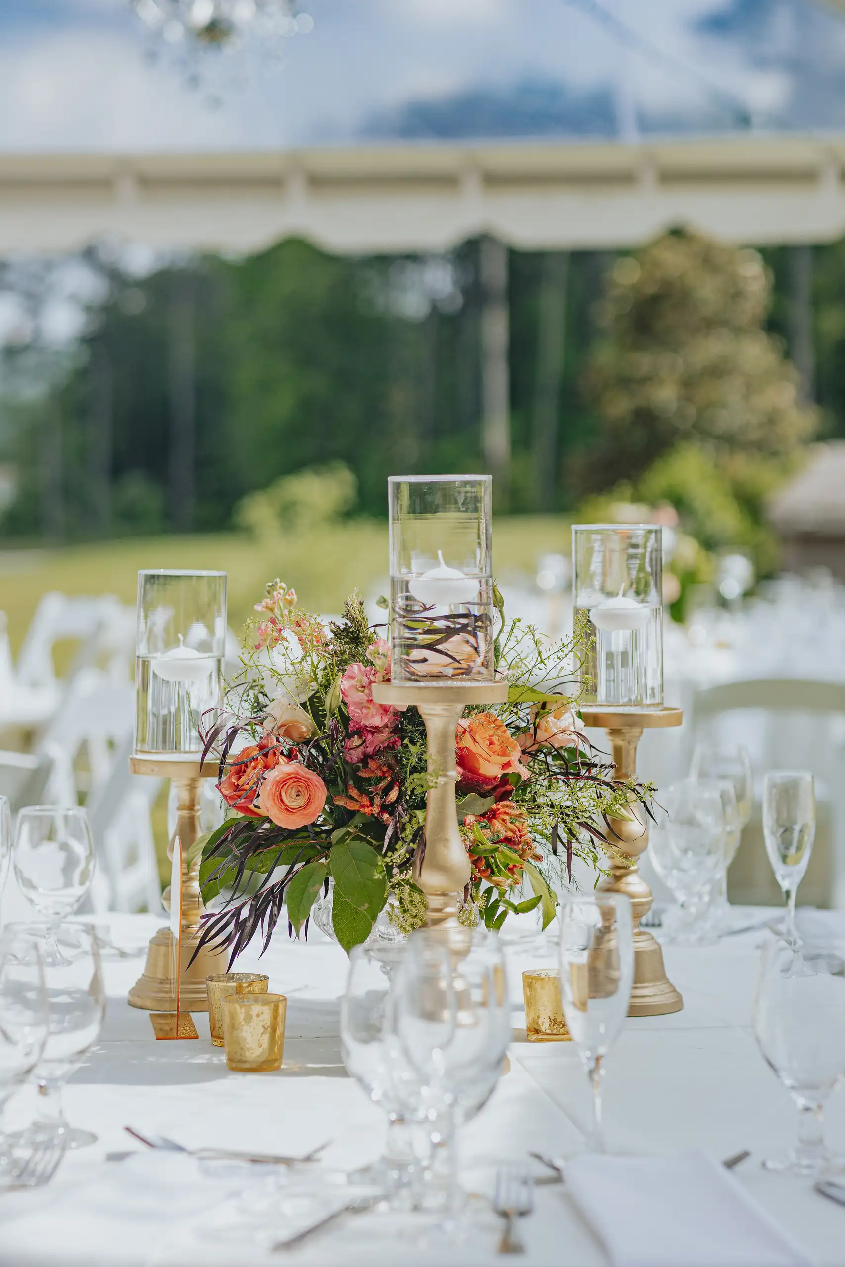 Reception Details: the gold candlesticks and the centerpiece on the long table, at a wedding at Callaway Gardens in Pine Mountain, GA