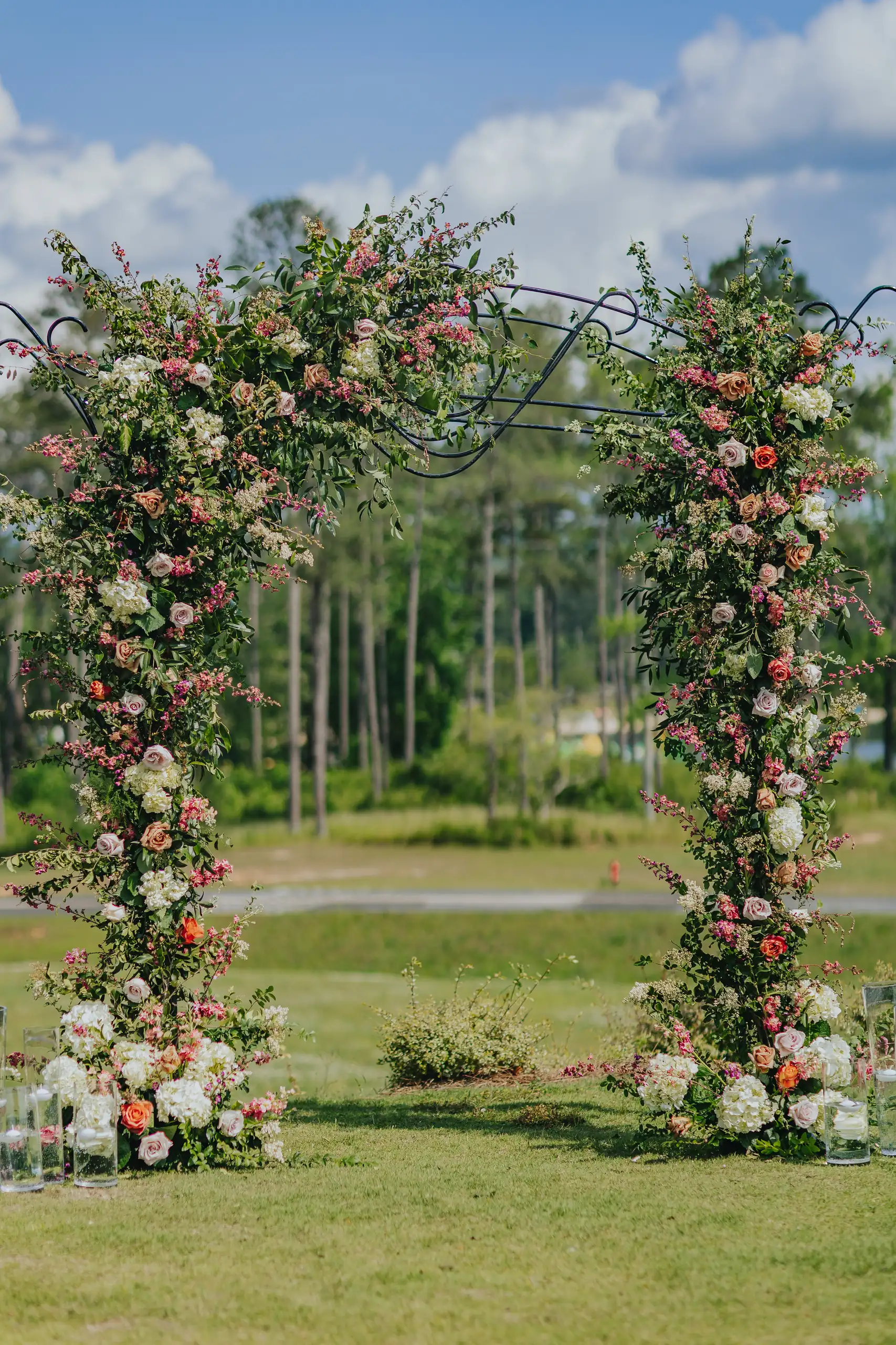 Wedding Ceremony: the arch covered in climbing roses on the lawn, at a wedding at Callaway Gardens in Pine Mountain, GA