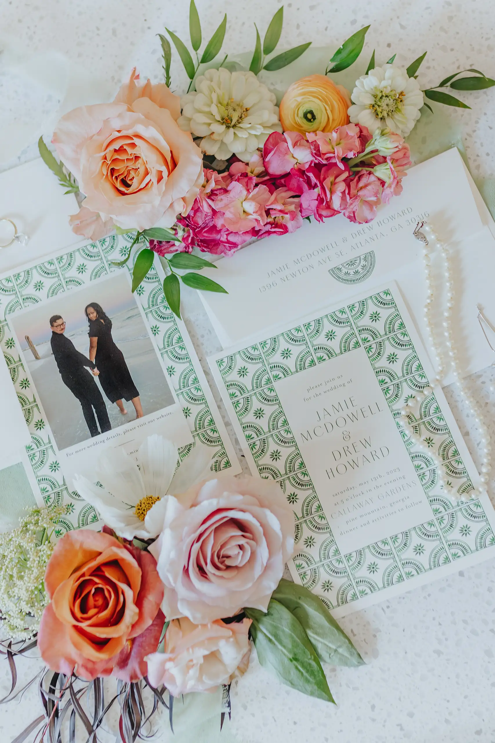 Wedding Details: the invitation with roses laid around it, at a wedding at Callaway Gardens in Pine Mountain, GA