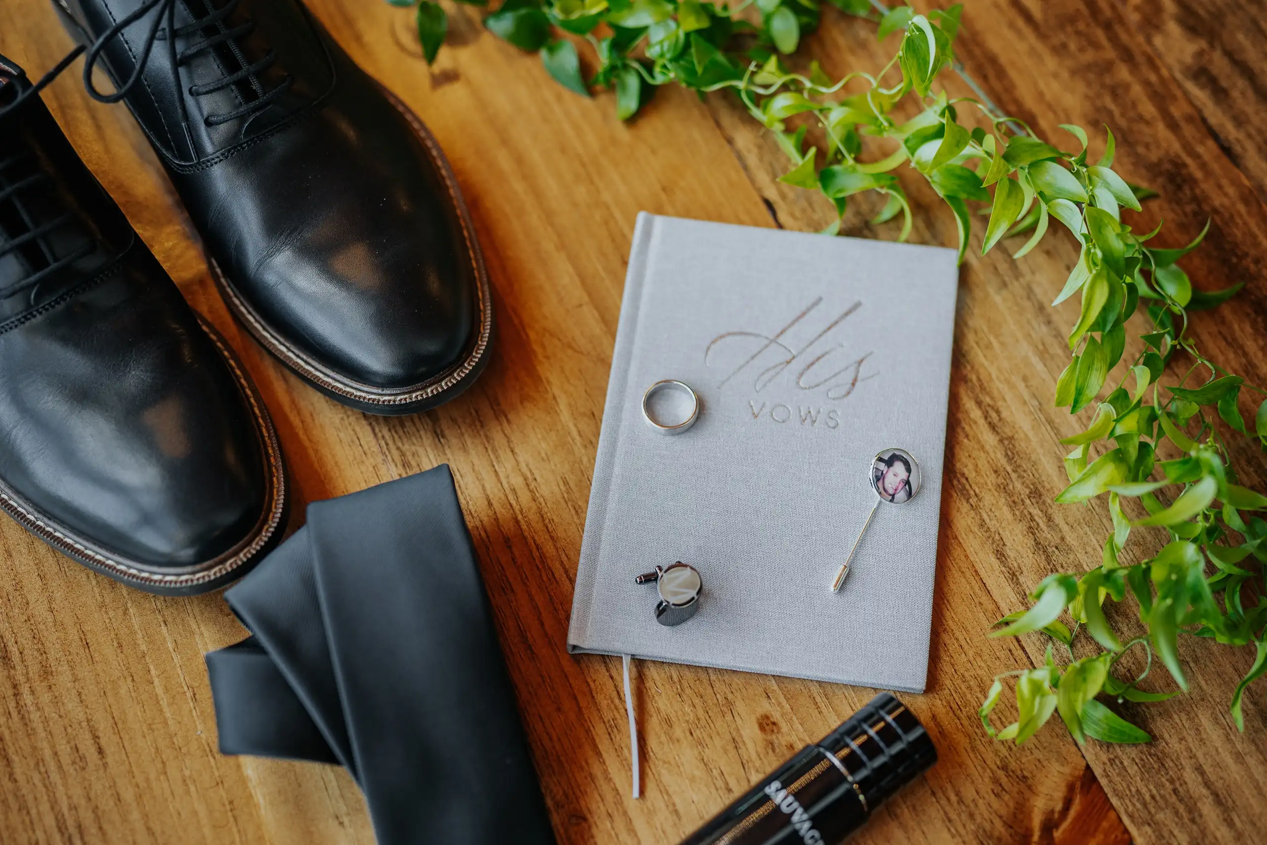 Wedding Details: the groom's shoes, vow book and cufflinks, at a wedding at The Venue at Sharp Mountain in Jasper, GA