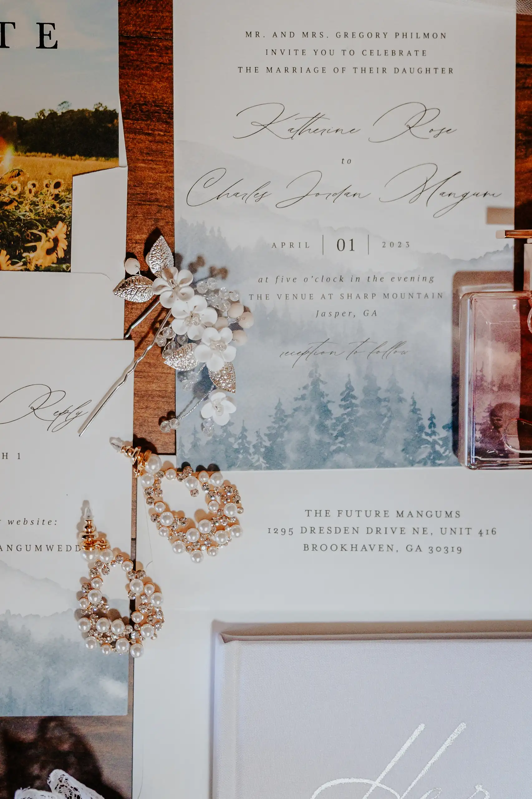 Wedding Details: the invitation suite with a mountain photograph, at a wedding at The Venue at Sharp Mountain in Jasper, GA