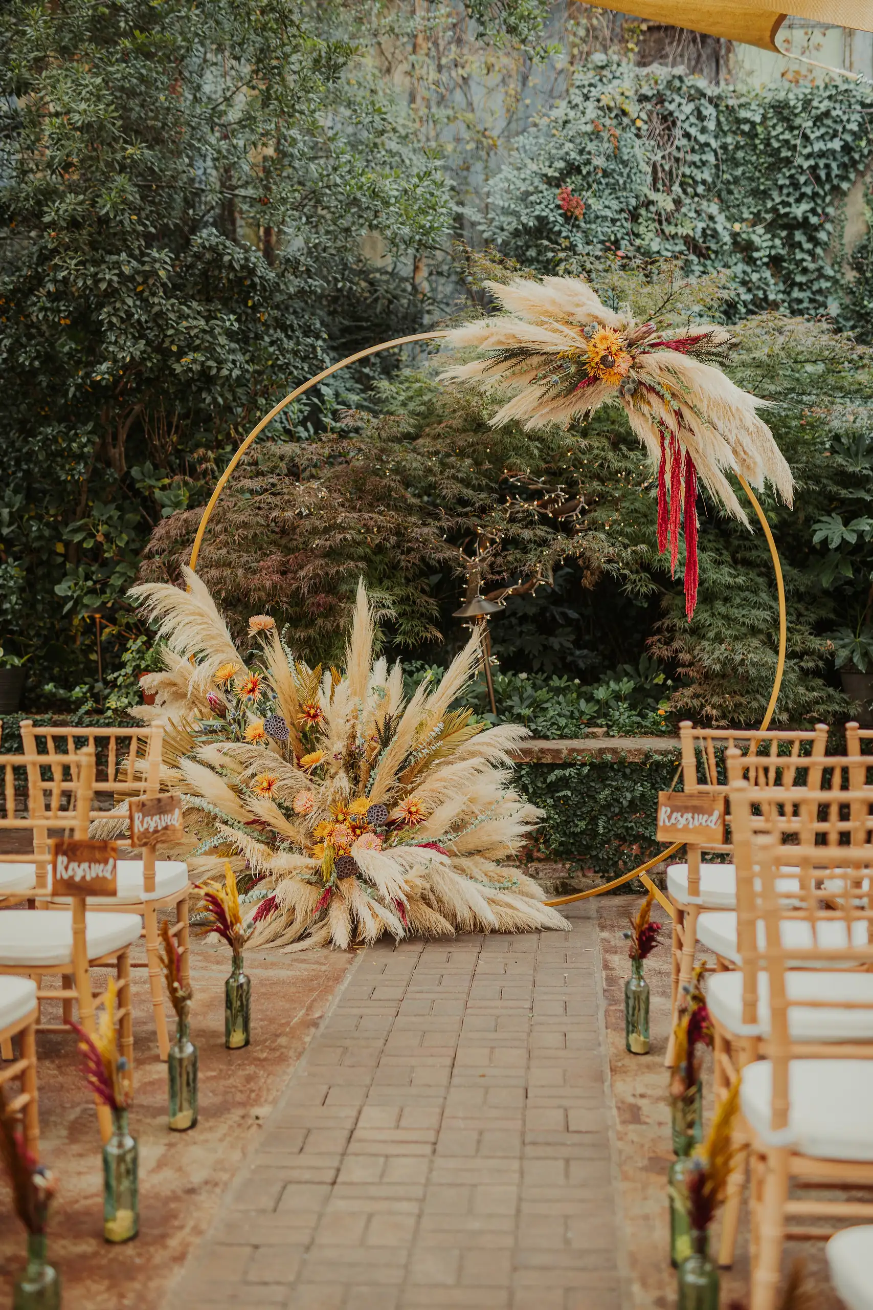 Wedding Ceremony: the pampas grass ring standing in the garden, at a wedding at Wahoo! Grill in Decatur, GA
