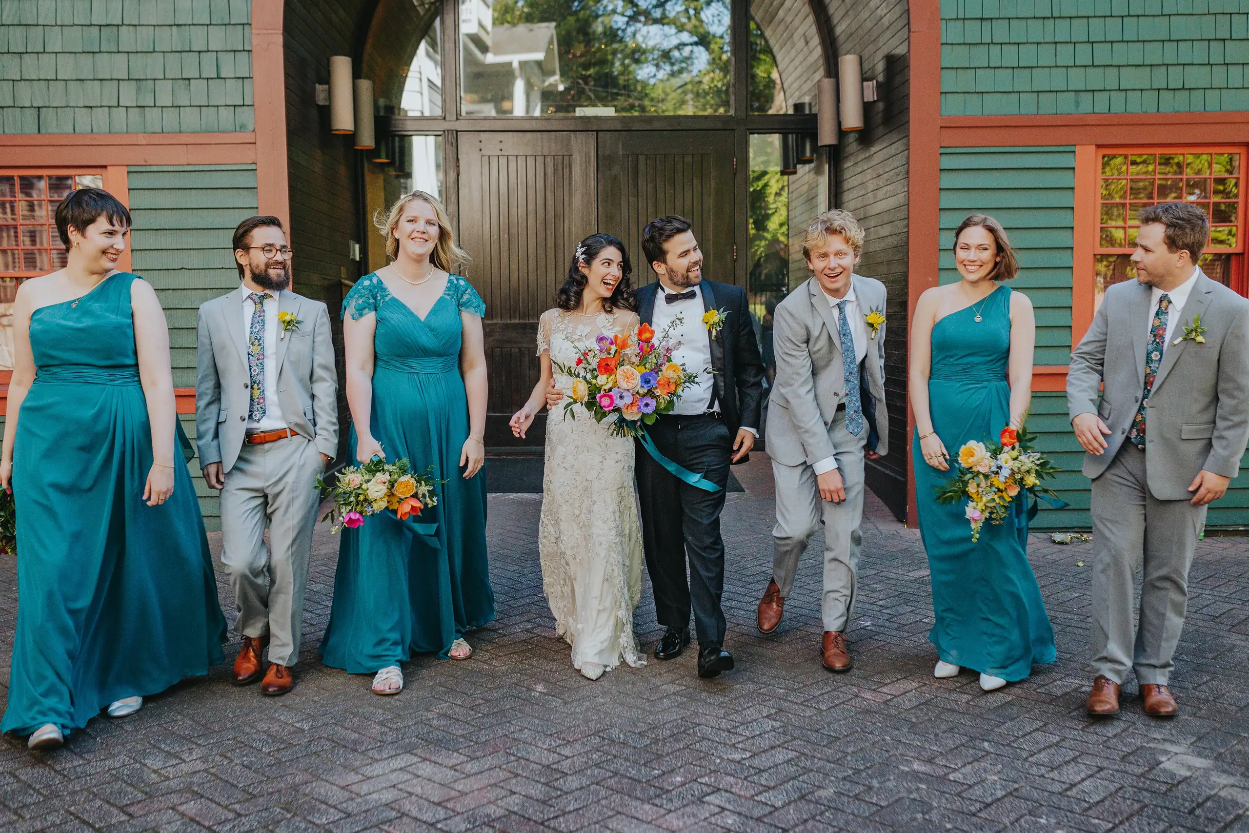 Wedding Party: the whole bridal party walking the brick street, at their wedding at the Trolley Barn in Atlanta, GA