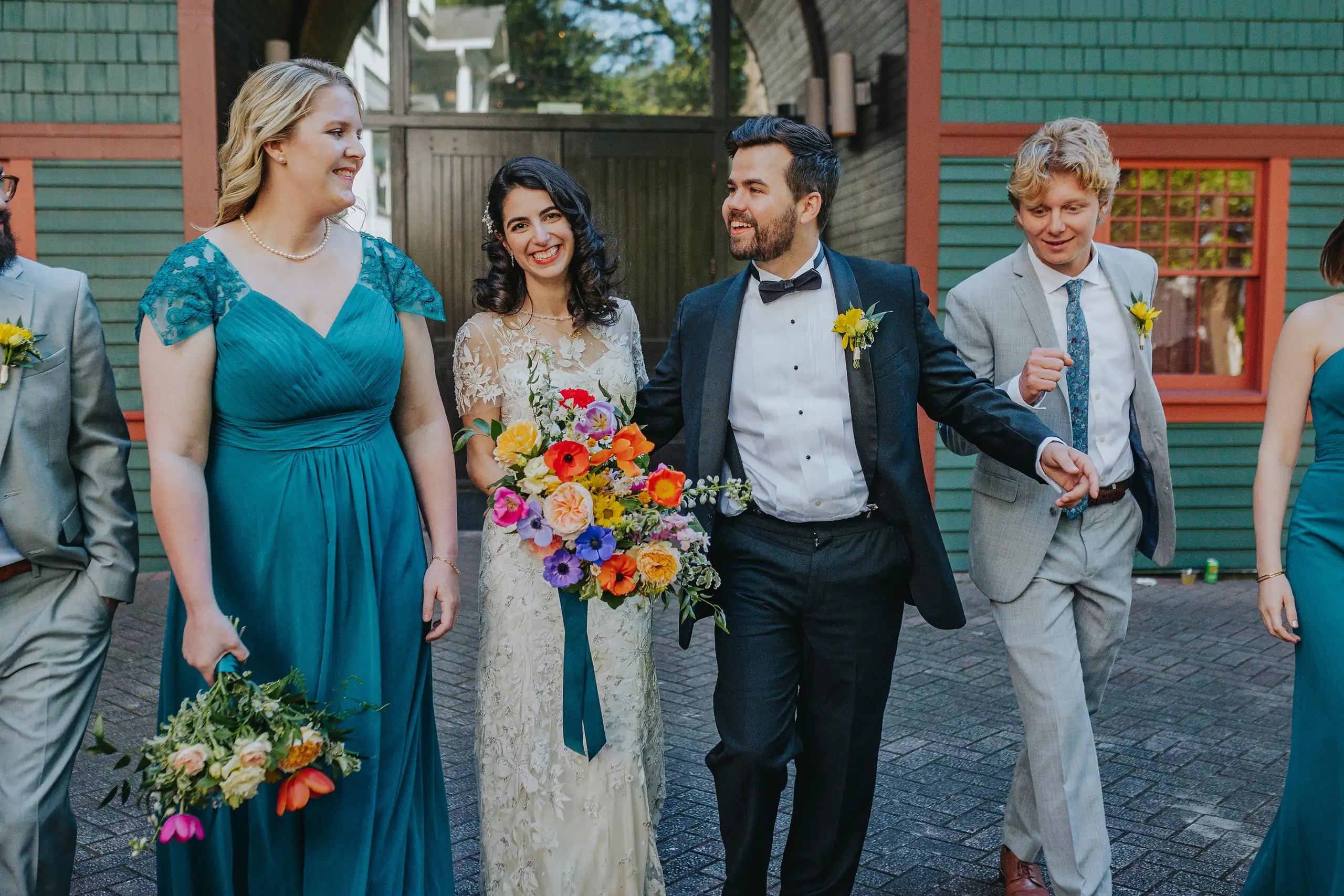 Wedding Party: the bridal party walking together, laughing, at their wedding at the Trolley Barn in Atlanta, GA