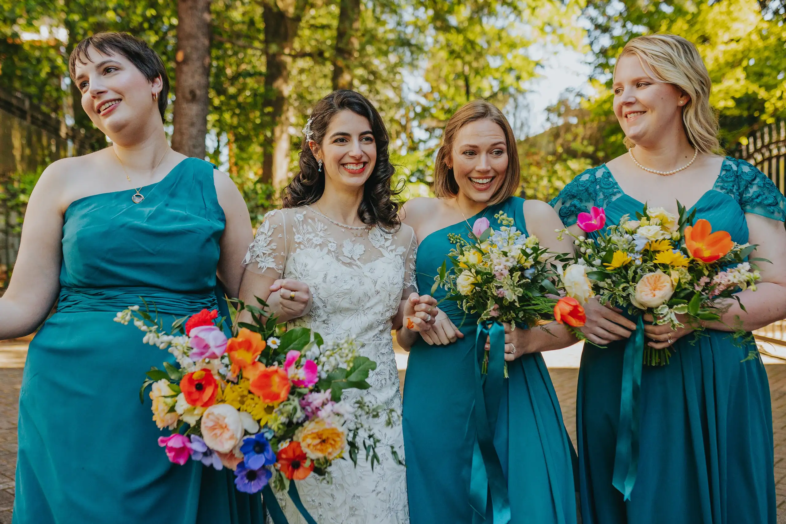Wedding Party: the bride with her bridesmaids in teal, at their wedding at the Trolley Barn in Atlanta, GA