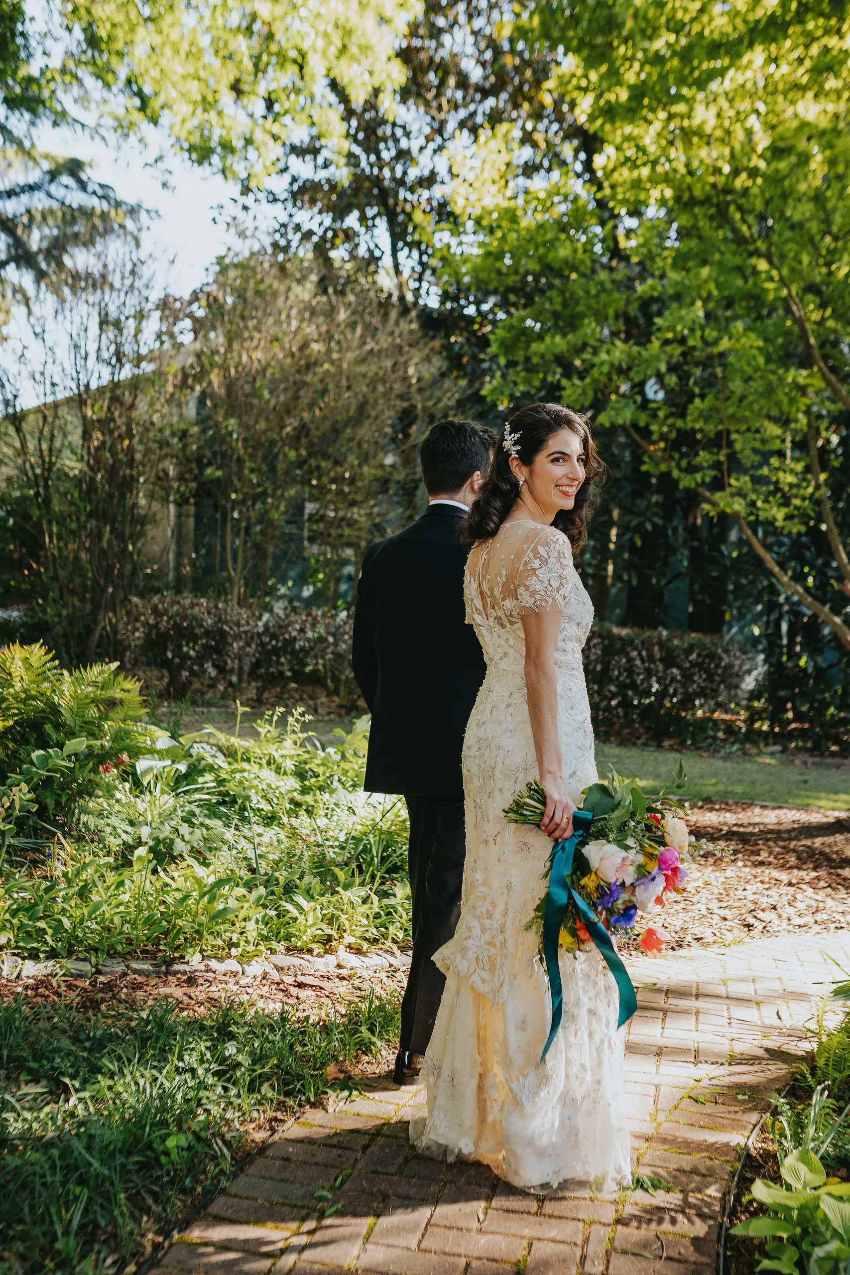 Wedding Formals: the couple walking the garden path, at their wedding at the Trolley Barn in Atlanta, GA
