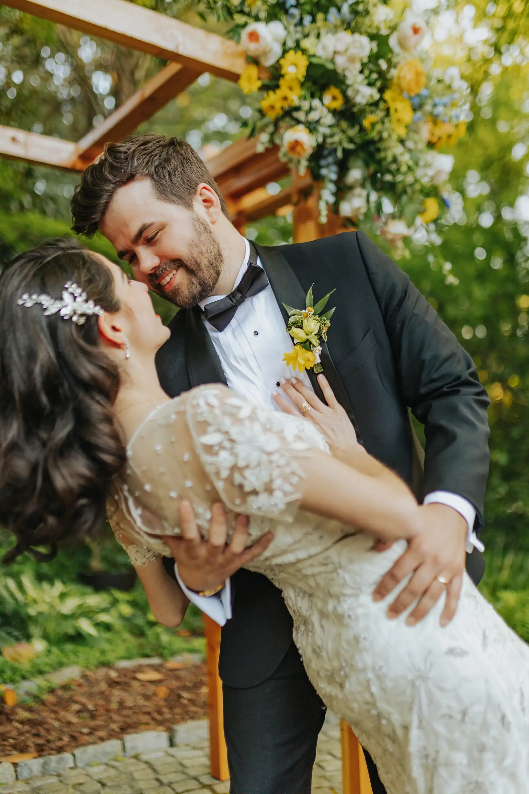 Wedding Formals: the groom dipping the bride under the arch, at their wedding at the Trolley Barn in Atlanta, GA