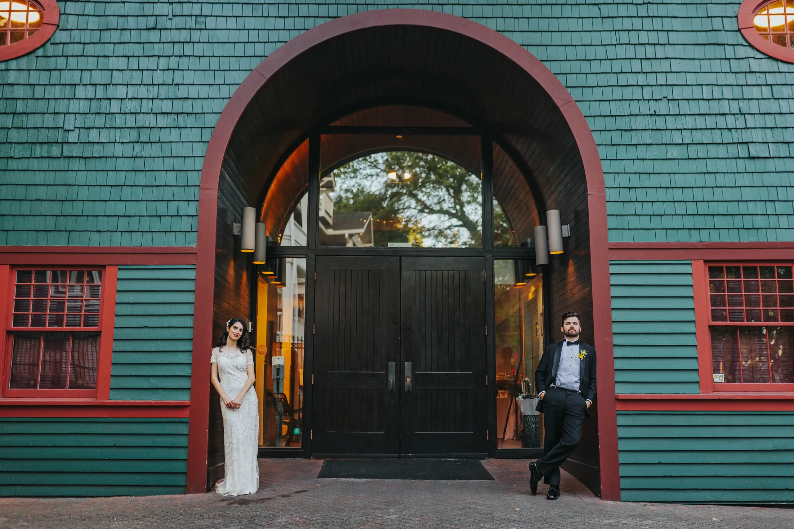 Wedding Formals: the couple either side of the arched entrance, at their wedding at the Trolley Barn in Atlanta, GA