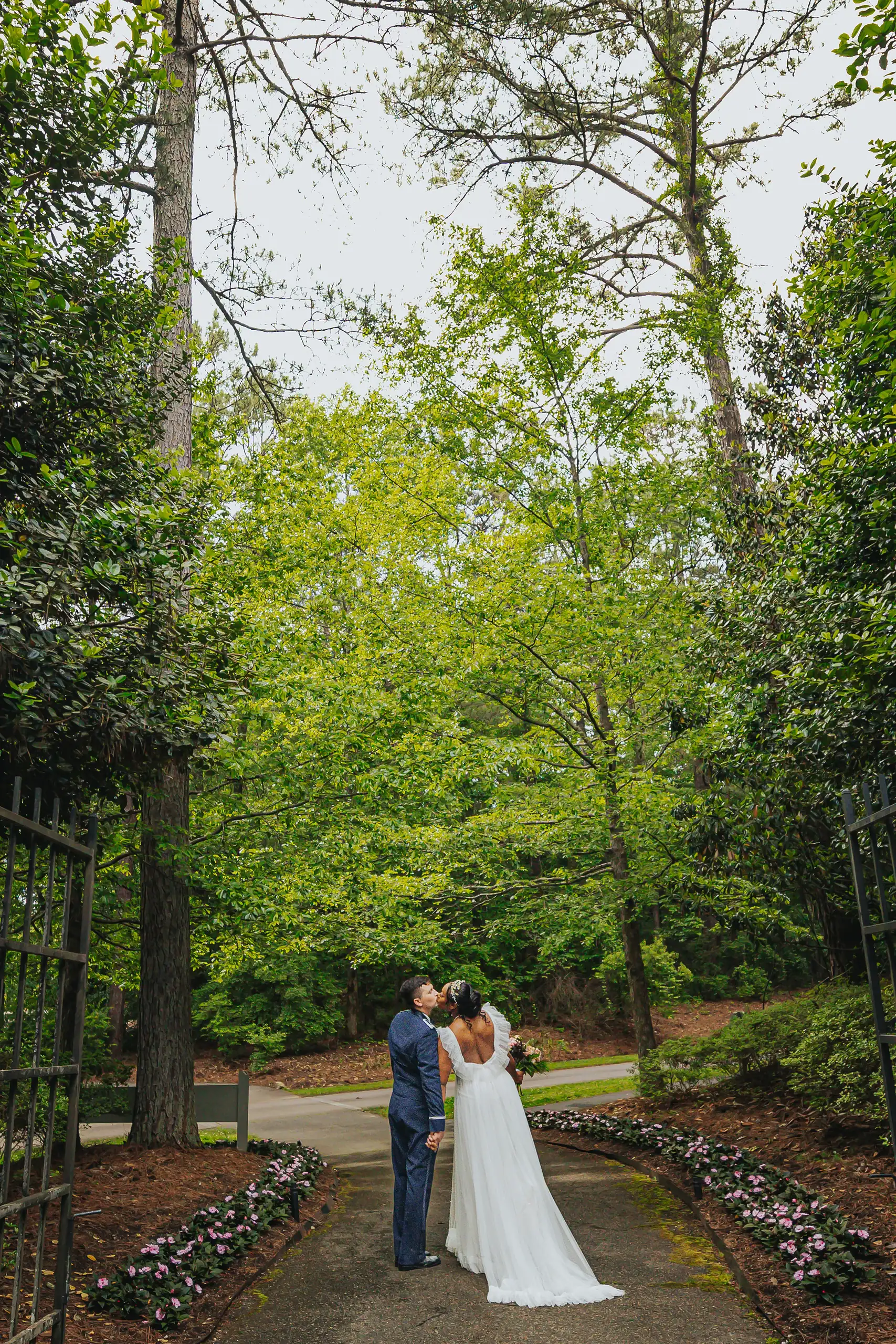 Wedding Formals: the two of them small among the tall garden trees, at their wedding at Callaway Gardens in Pine Mountain, GA