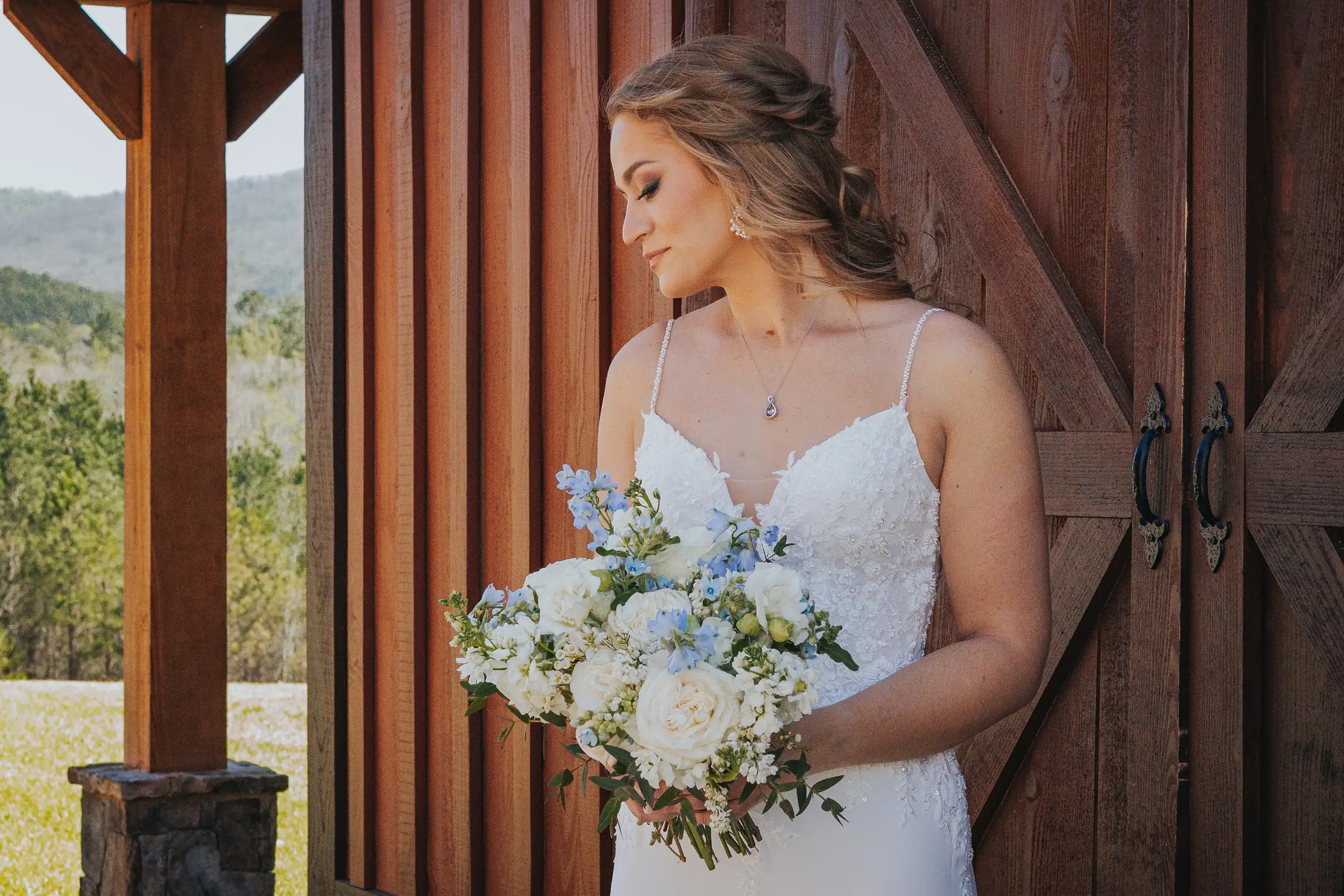 Bridal Portraits: the mountain view, and the bride at the doors, at their wedding at The Venue at Sharp Mountain in Jasper, GA