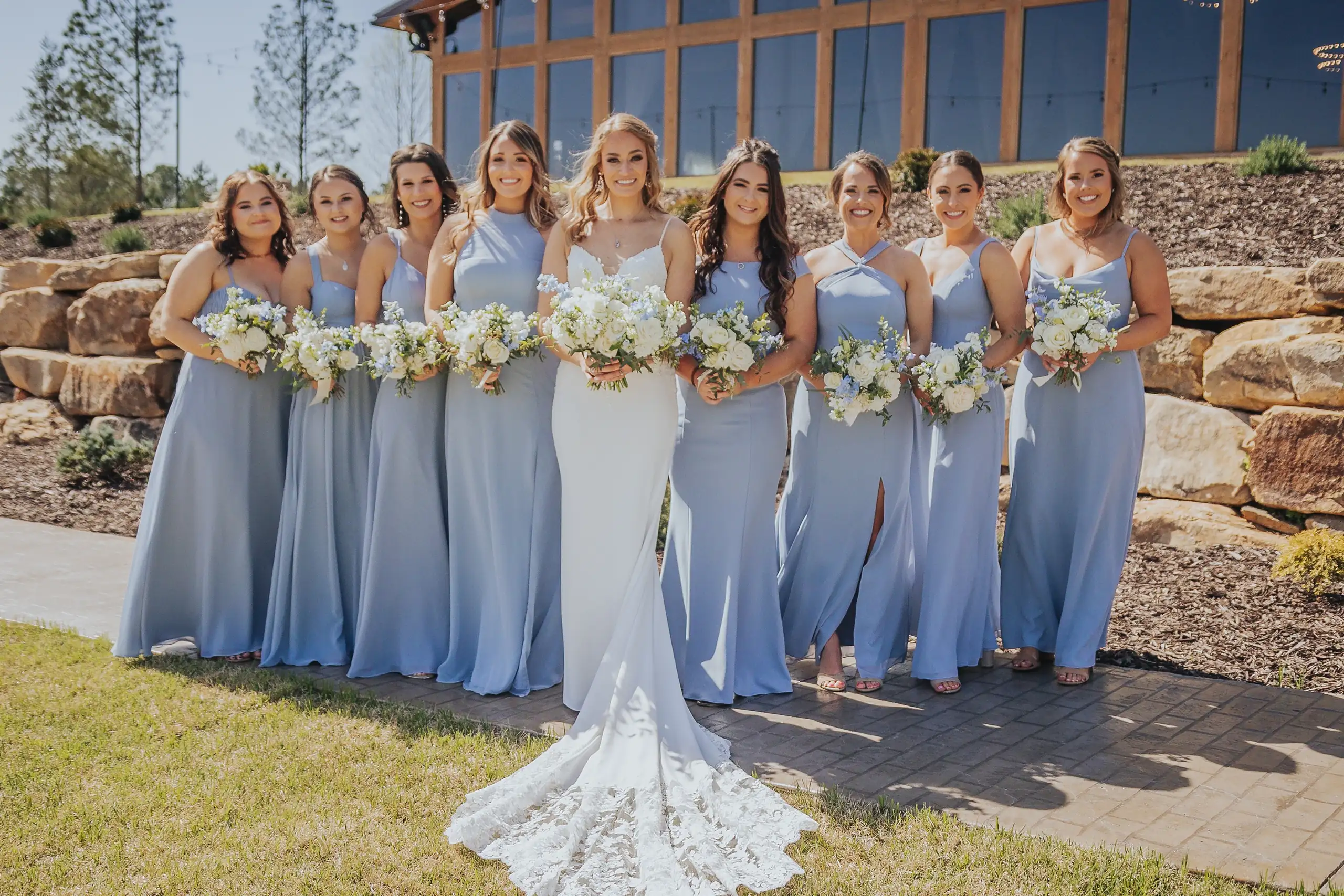 Wedding Party: the bride and bridesmaids with a greenery garland, at their wedding at The Venue at Sharp Mountain in Jasper, GA