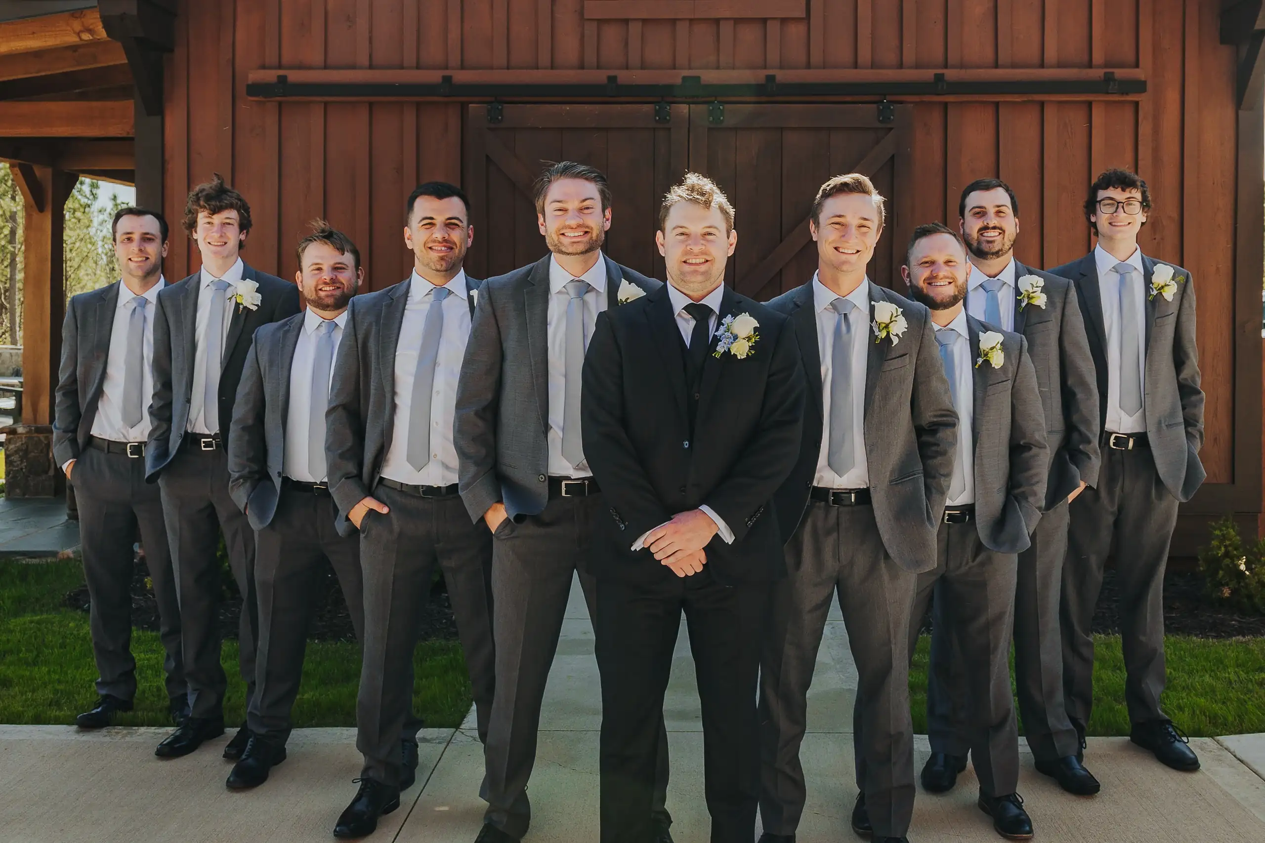 Wedding Party: the groomsmen lined up out on the lawn, at their wedding at The Venue at Sharp Mountain in Jasper, GA