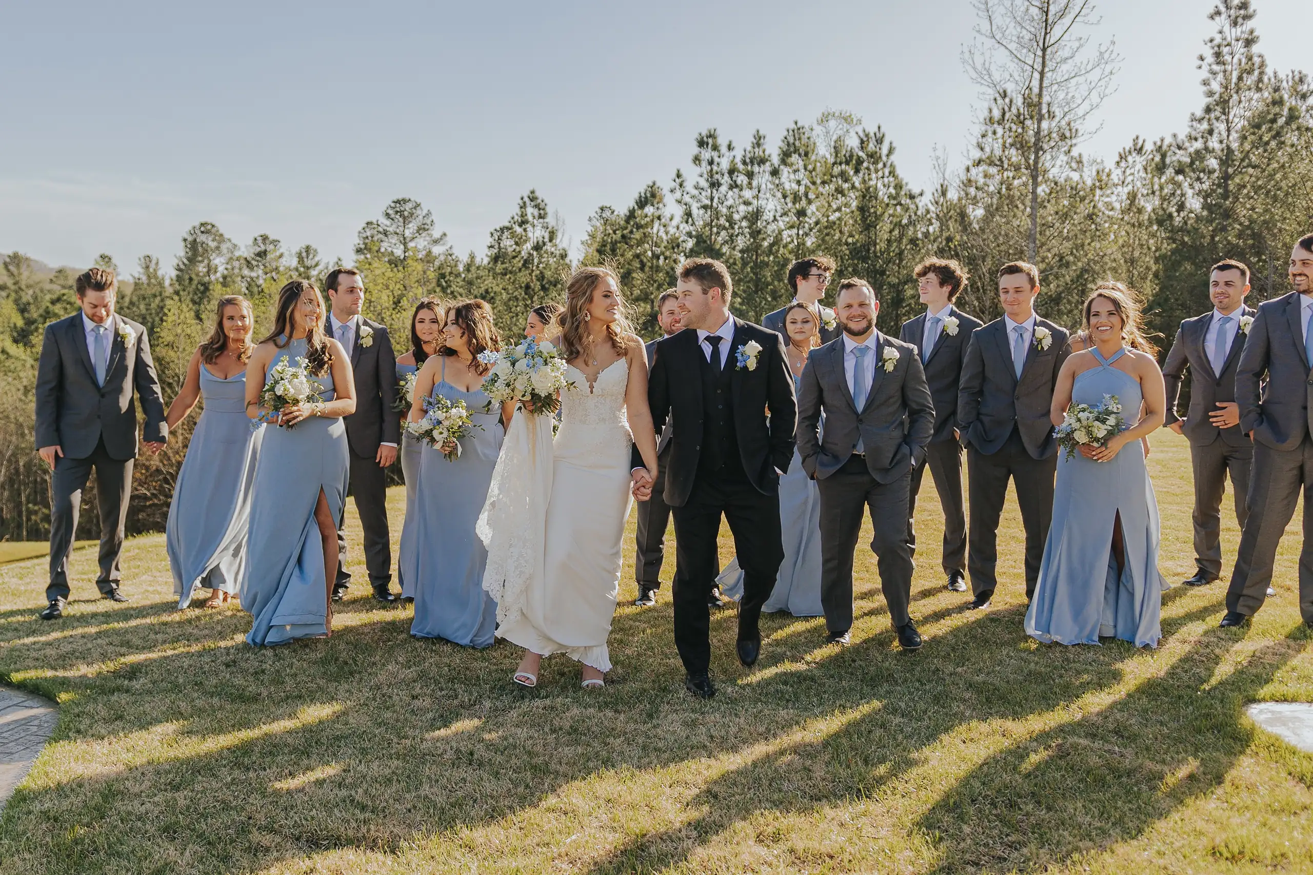 Wedding Party: the whole bridal party walking the lawn, at their wedding at The Venue at Sharp Mountain in Jasper, GA