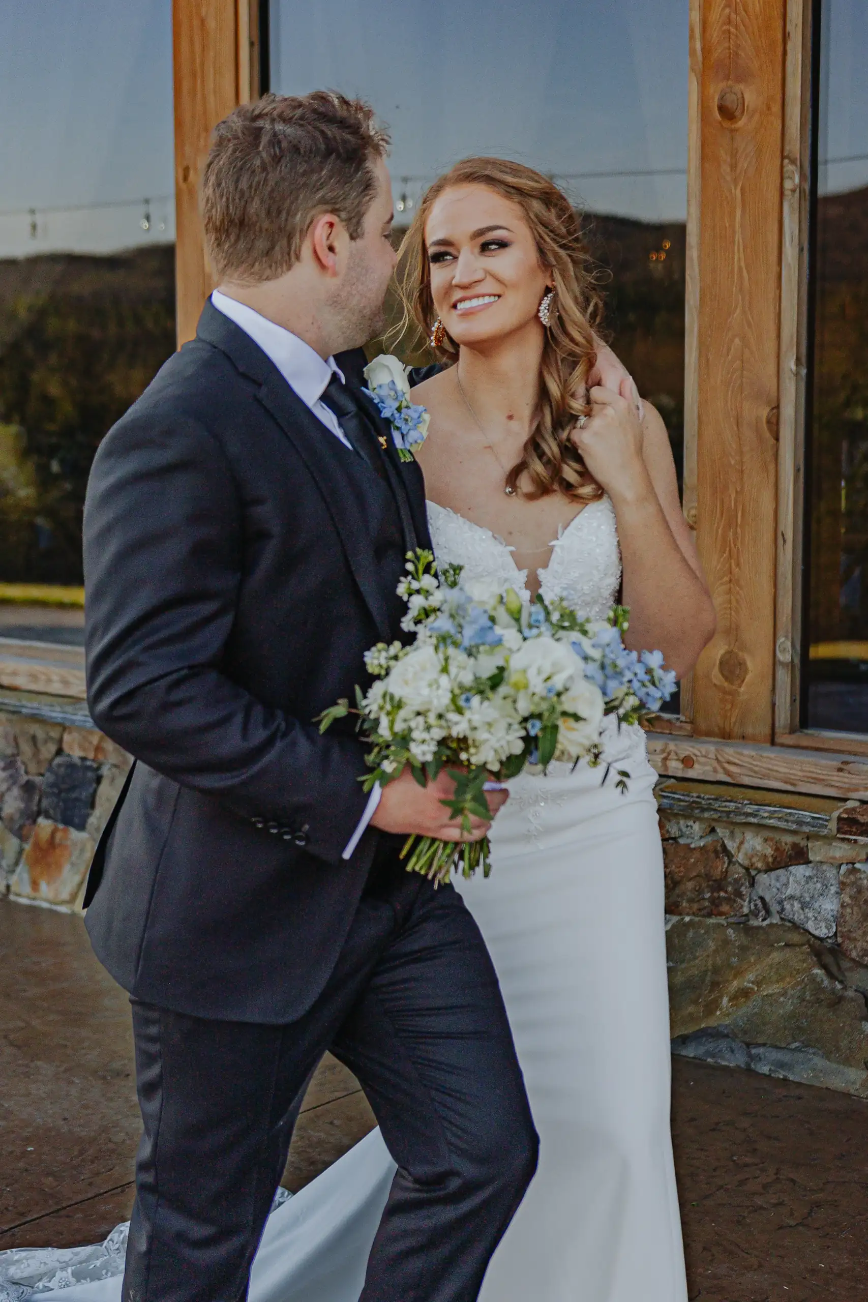 Wedding Formals: the couple close, her bouquet between them, at their wedding at The Venue at Sharp Mountain in Jasper, GA