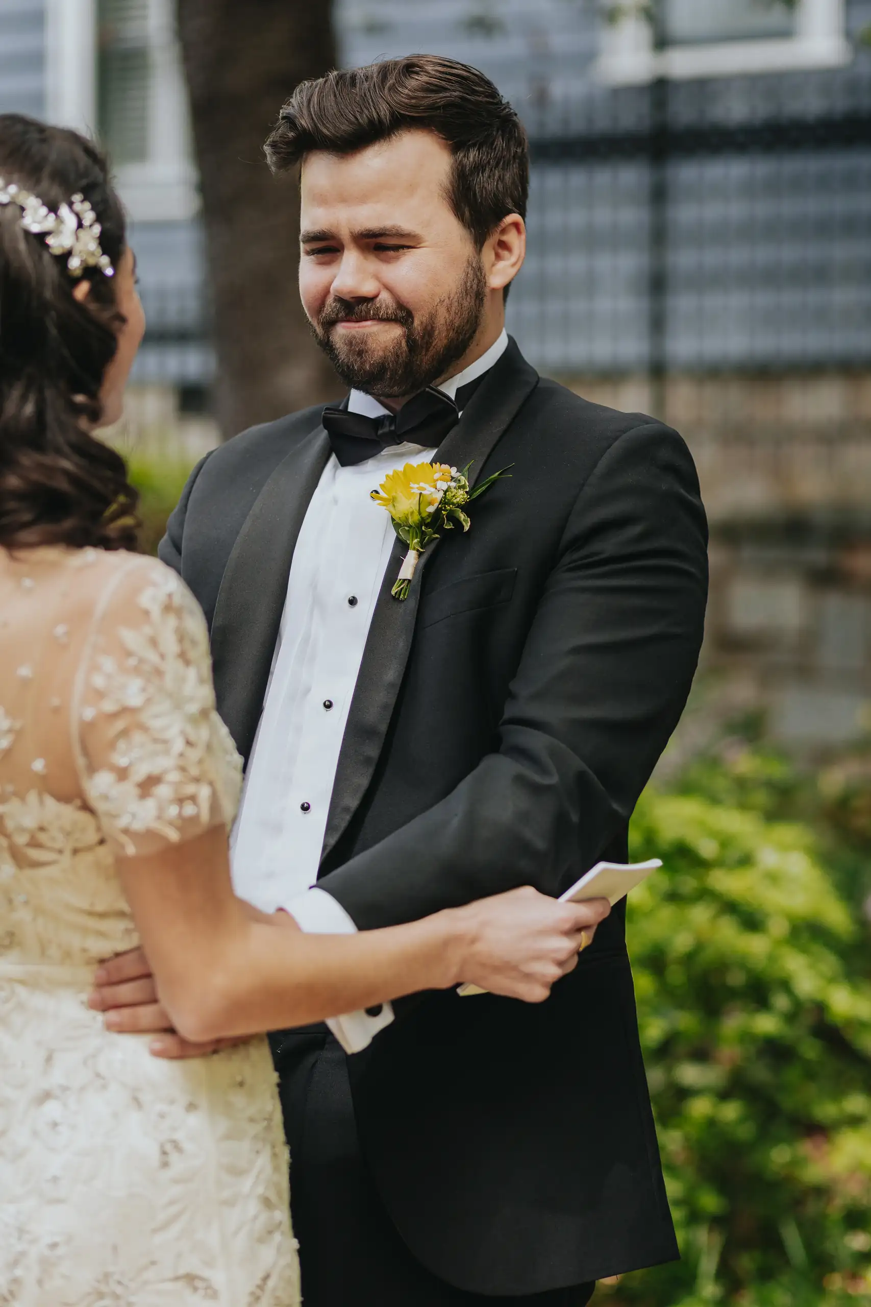 First Look: the groom holding the bride, his vow book in hand, before their wedding at the Trolley Barn in Atlanta, GA