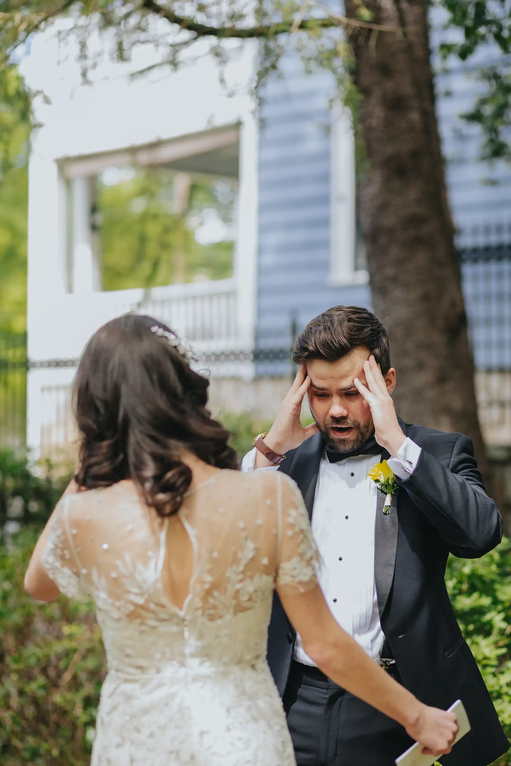 First Look: the groom wiping his eyes as the bride waits, before their wedding at the Trolley Barn in Atlanta, GA
