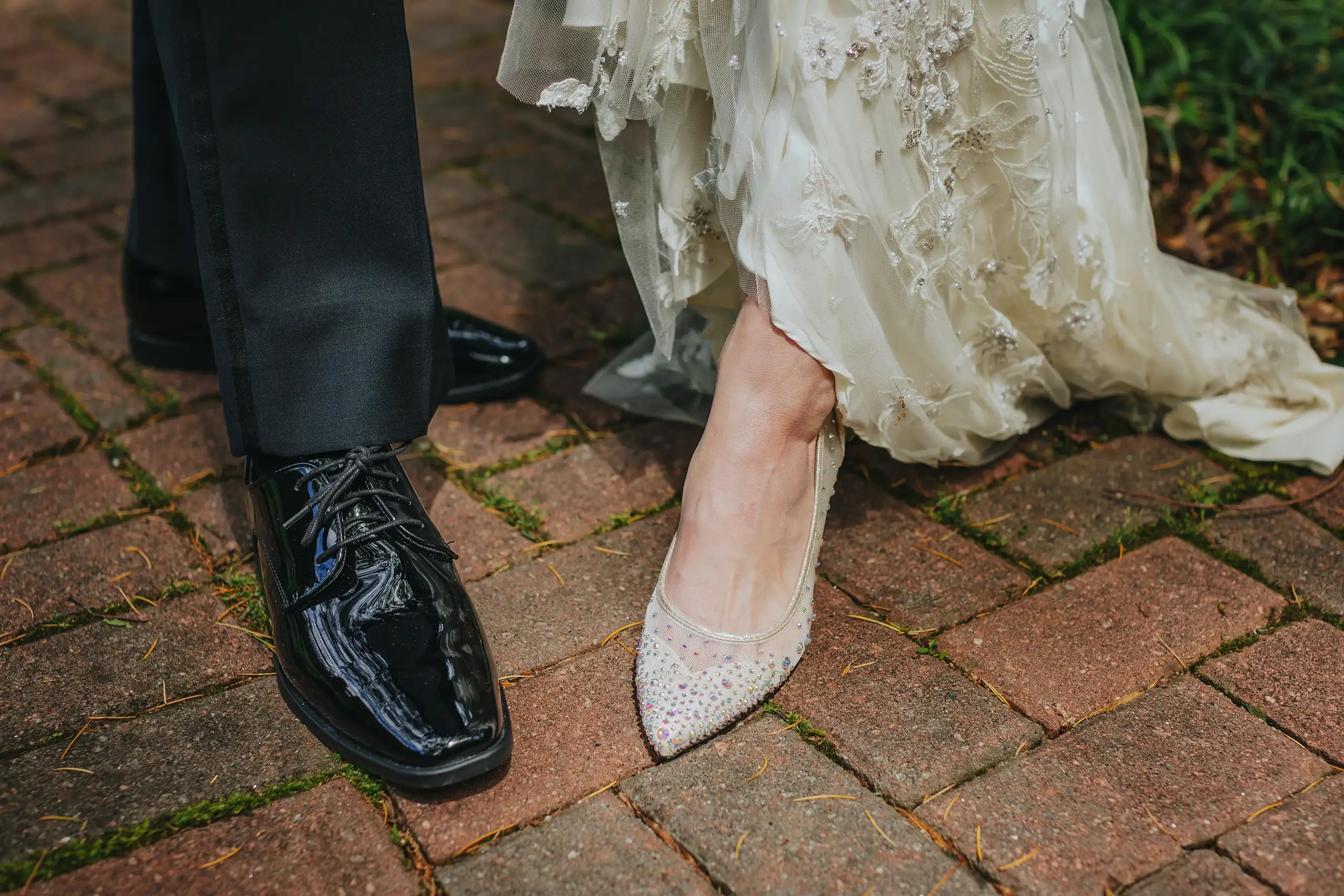 Wedding Details: the couple's shoes side by side on the brick, at a wedding at the Trolley Barn in Atlanta, GA