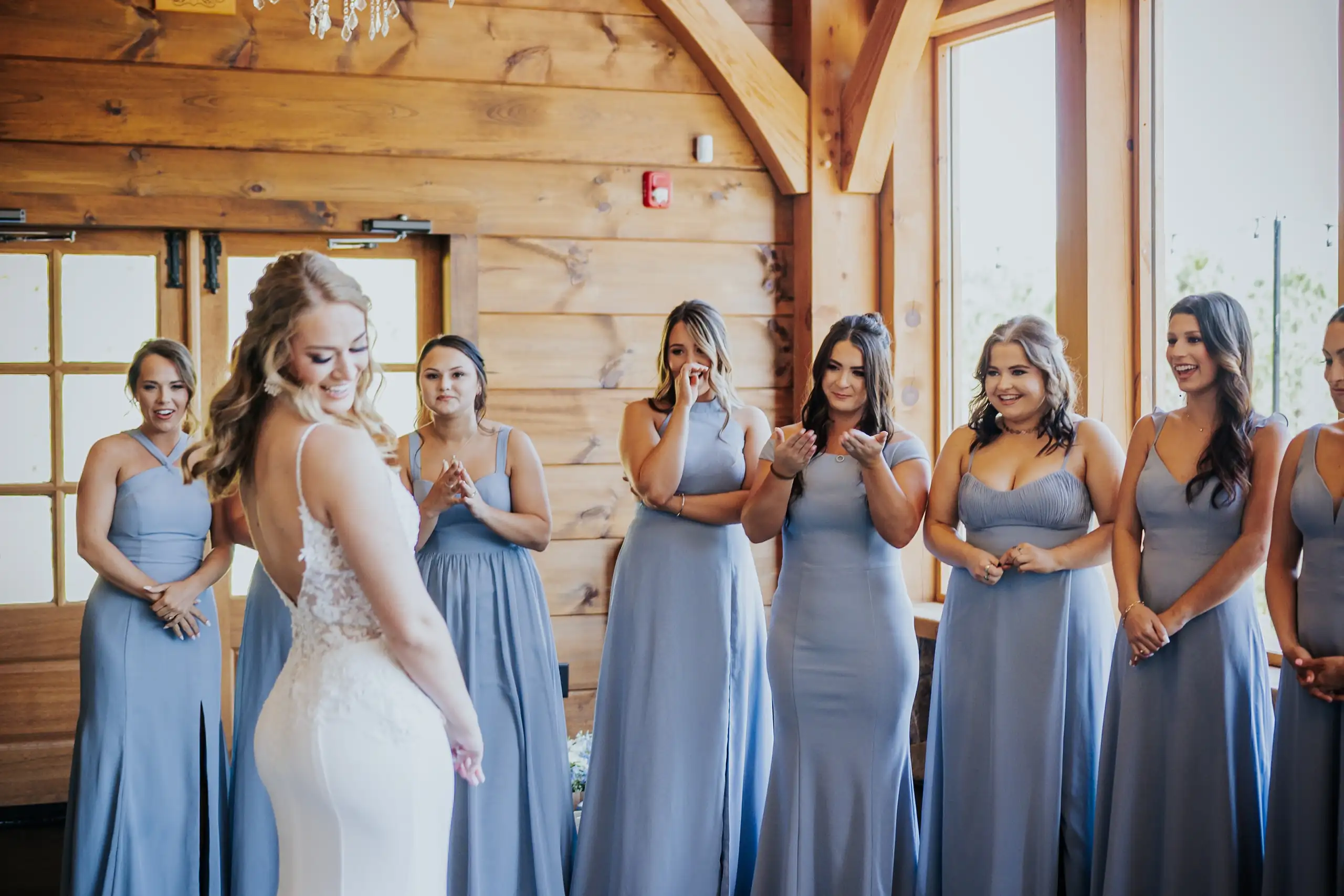 First Look: the bridesmaids seeing the bride, all emotional, before their wedding at The Venue at Sharp Mountain in Jasper, GA