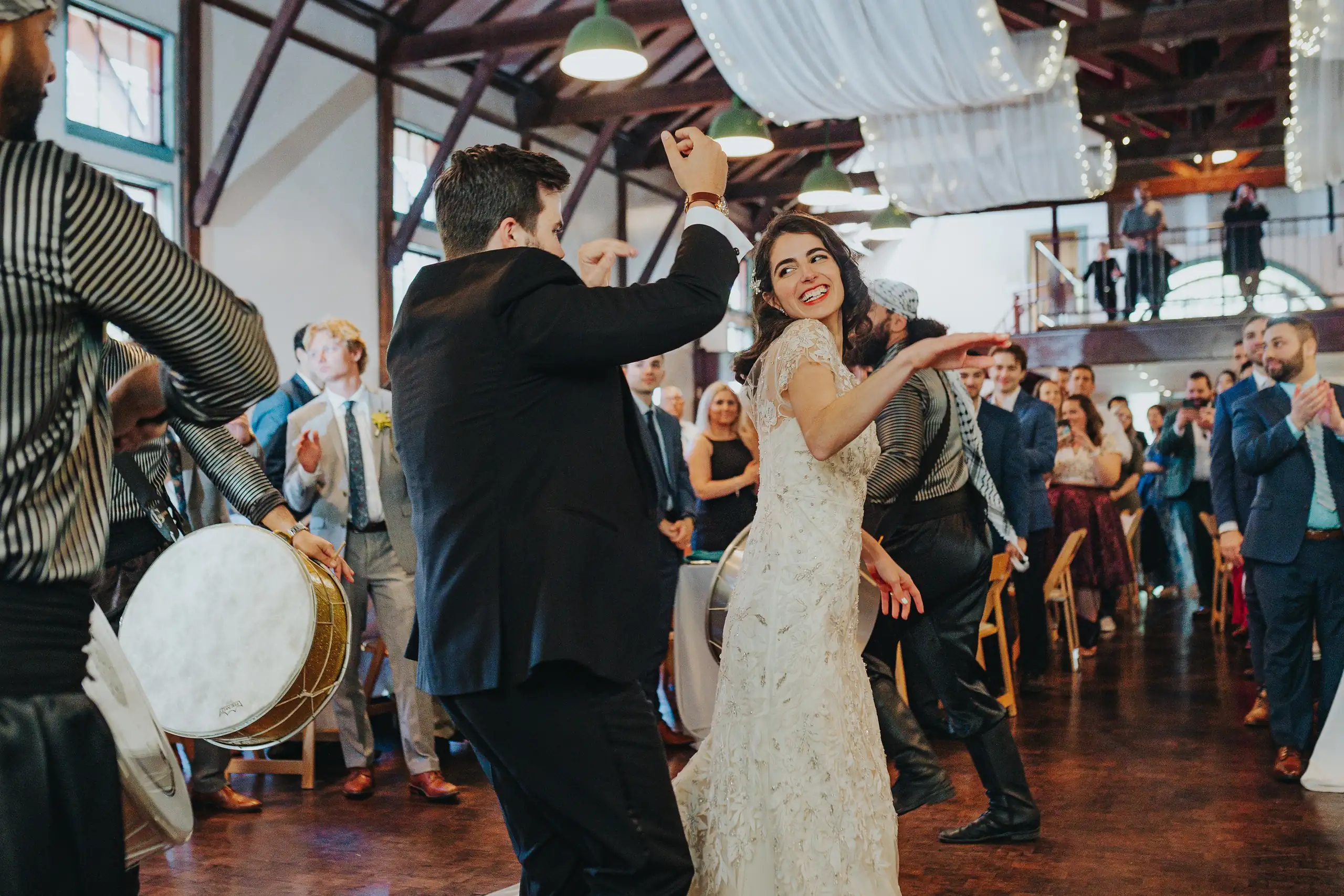 Wedding Reception: a drummer playing beside the dancing couple, at their wedding at the Trolley Barn in Atlanta, GA