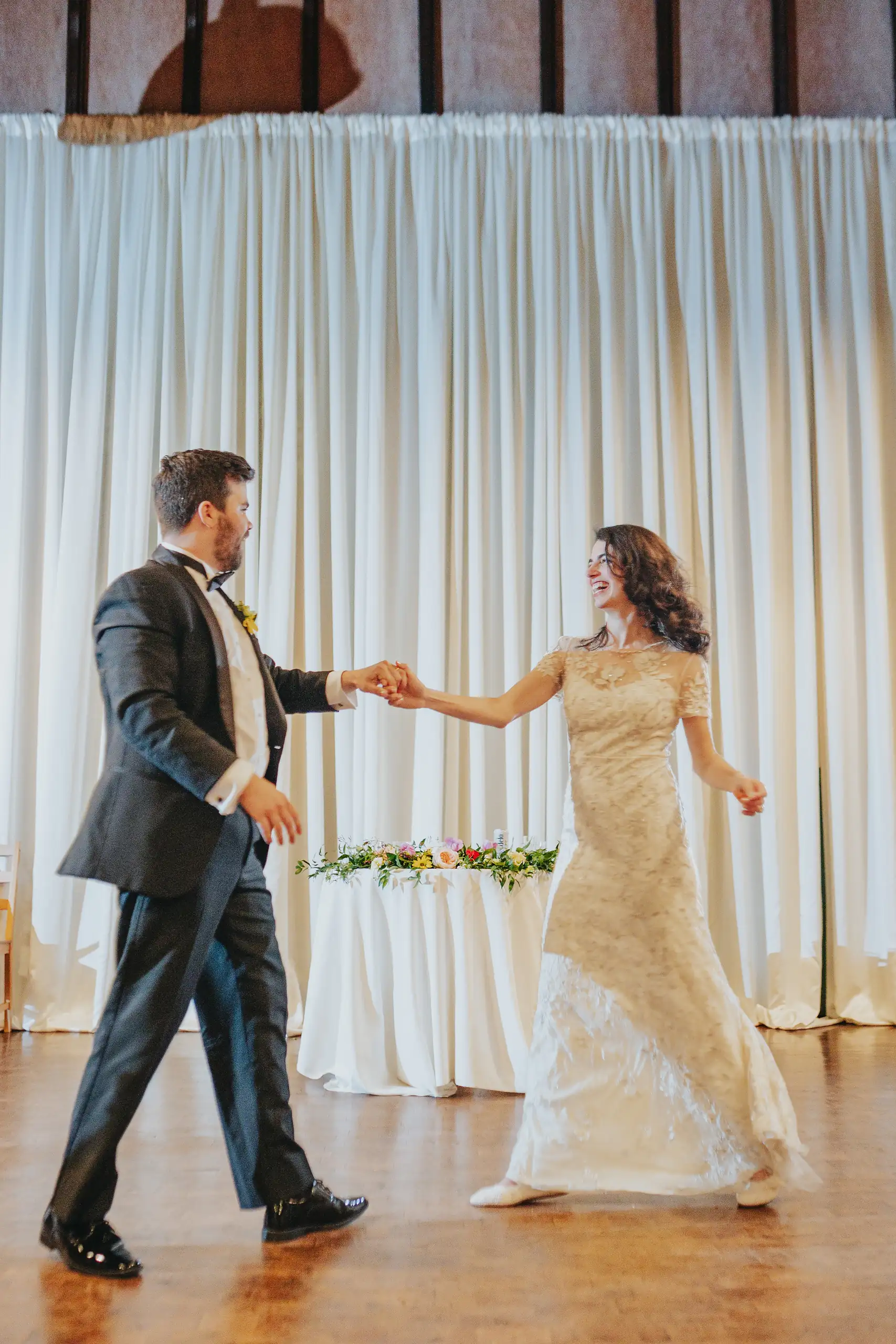 First Dance: the groom leading the bride into their dance, at their wedding at the Trolley Barn in Atlanta, GA