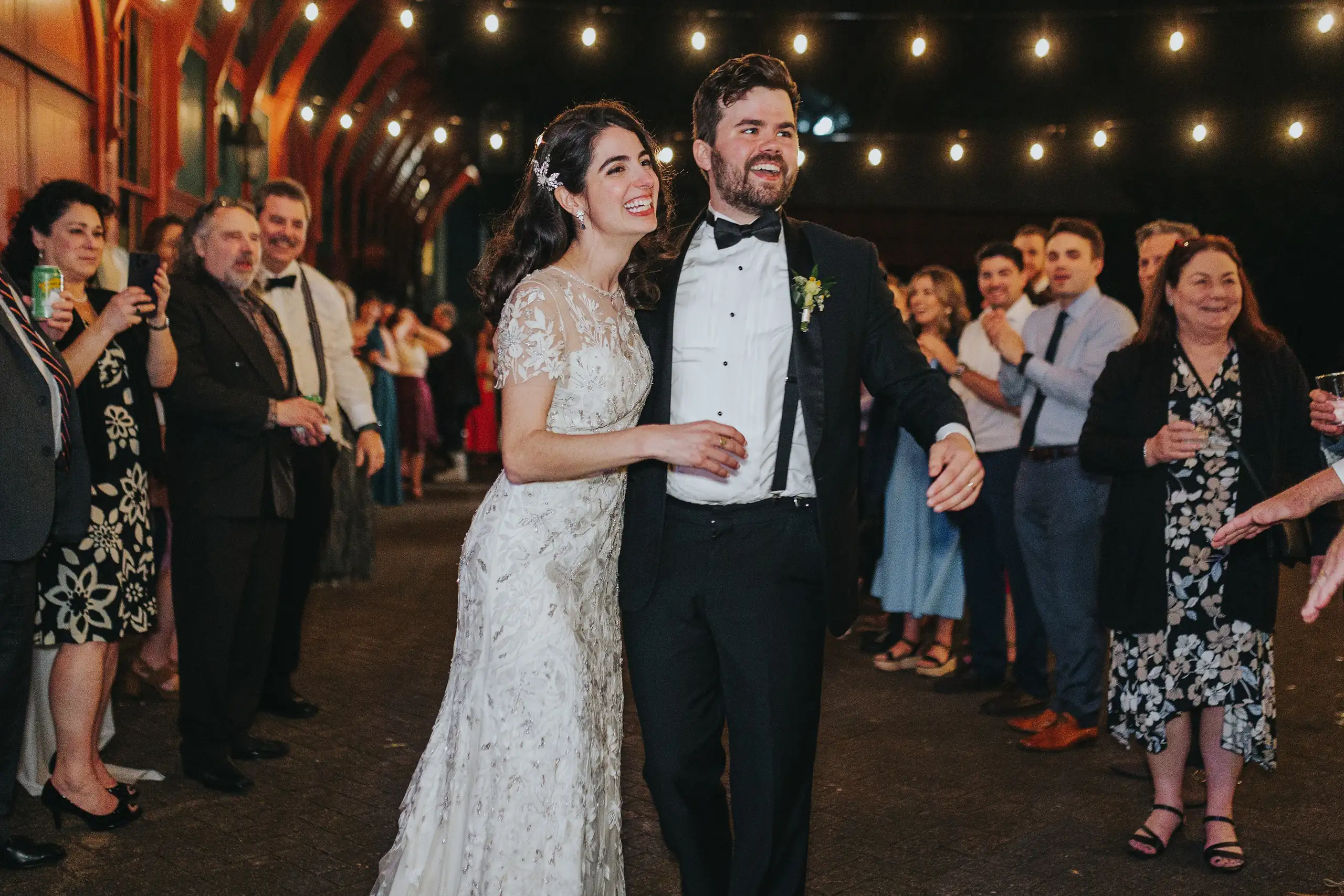 Wedding Reception: the couple walking out through the guests, at their wedding at the Trolley Barn in Atlanta, GA