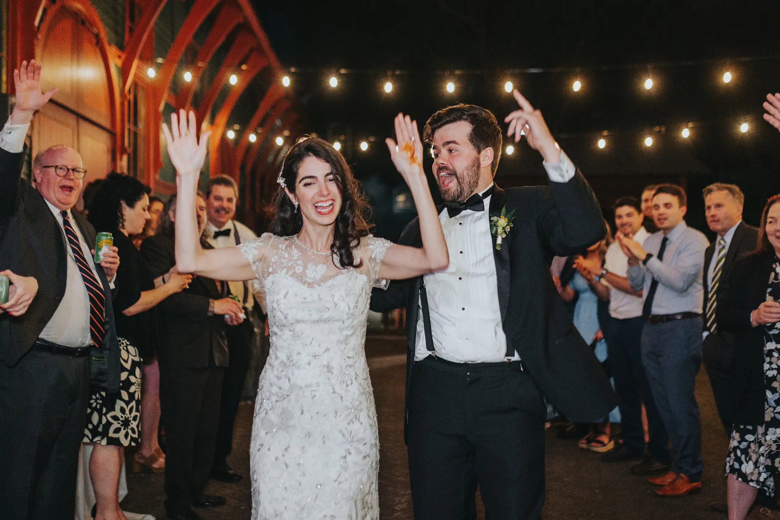 Wedding Reception: the couple with arms raised among their guests, at their wedding at the Trolley Barn in Atlanta, GA