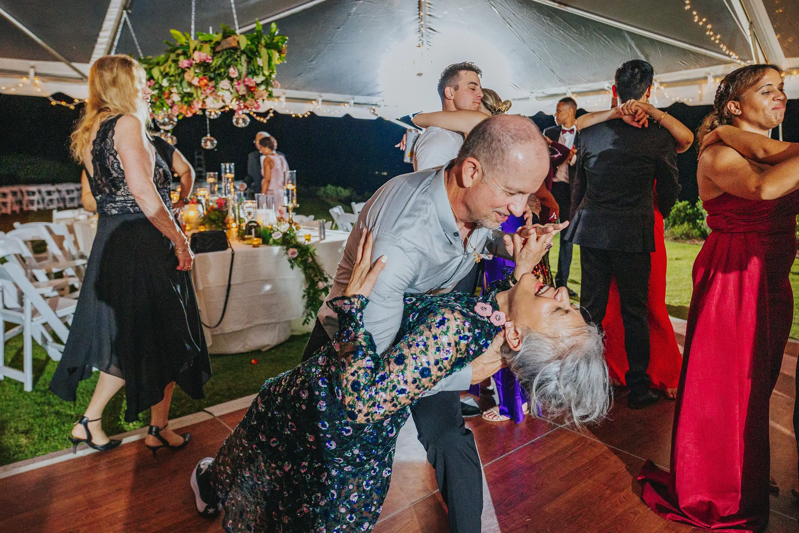 Wedding Reception: a guest dipping another on the dance floor, at their wedding at Callaway Gardens in Pine Mountain, GA