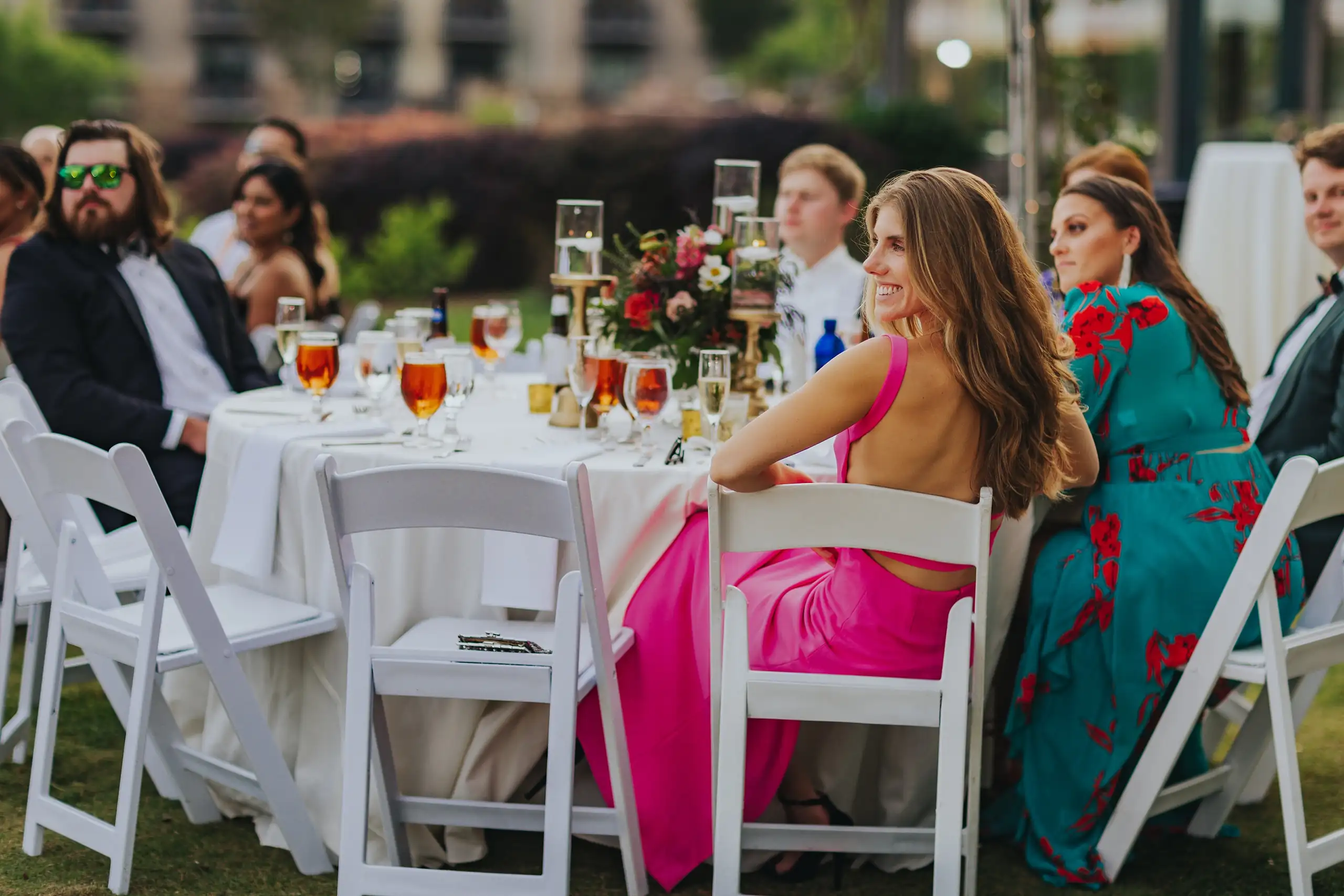 Wedding Reception: guests turning in their seats at the long table, at their wedding at Callaway Gardens in Pine Mountain, GA