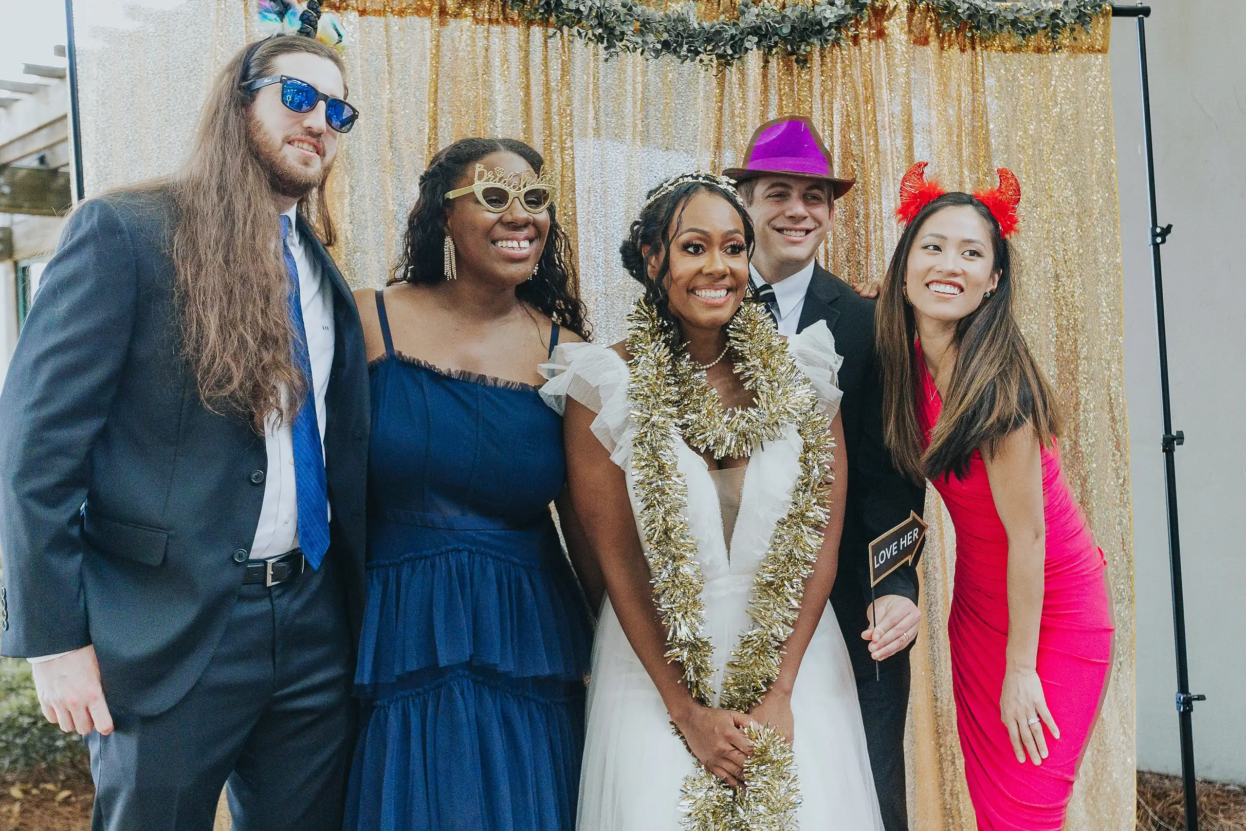 Wedding Reception: the couple with friends at the photo booth, at their wedding at Callaway Gardens in Pine Mountain, GA