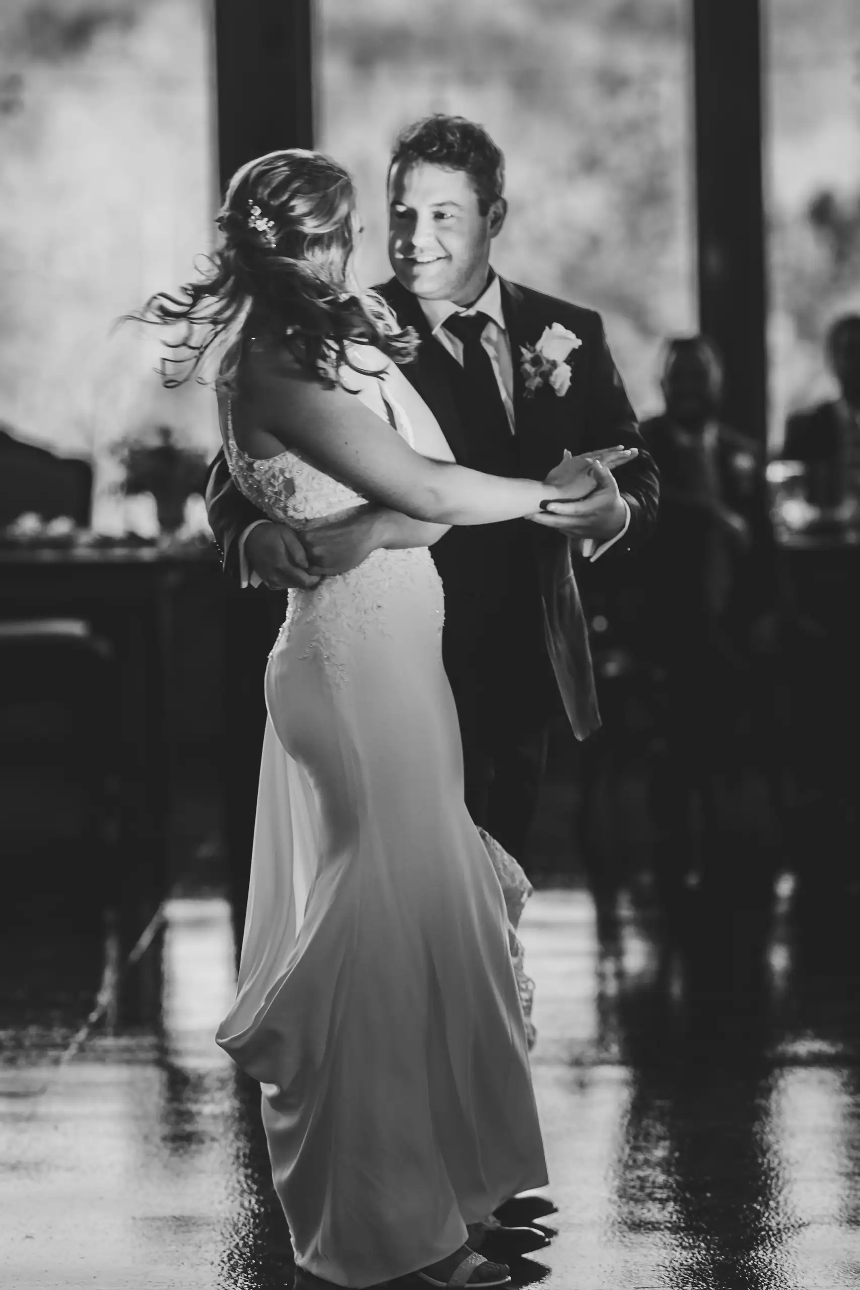 First Dance: the couple dancing, her skirt turning, at their wedding at The Venue at Sharp Mountain in Jasper, GA