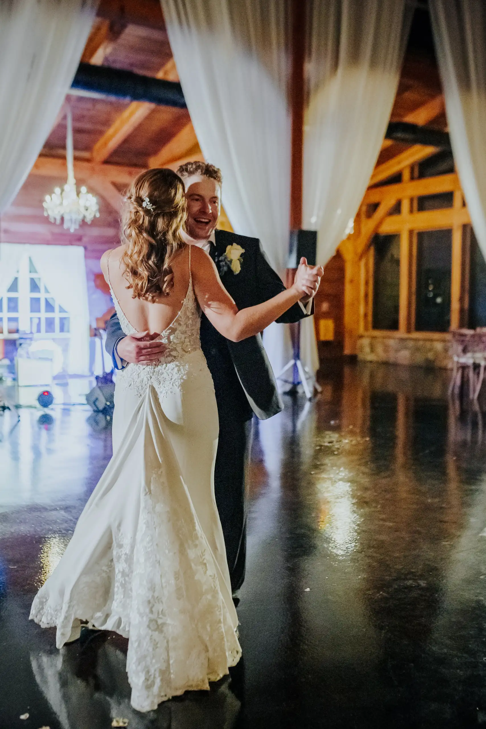 First Dance: the couple dancing before the draped window, at their wedding at The Venue at Sharp Mountain in Jasper, GA